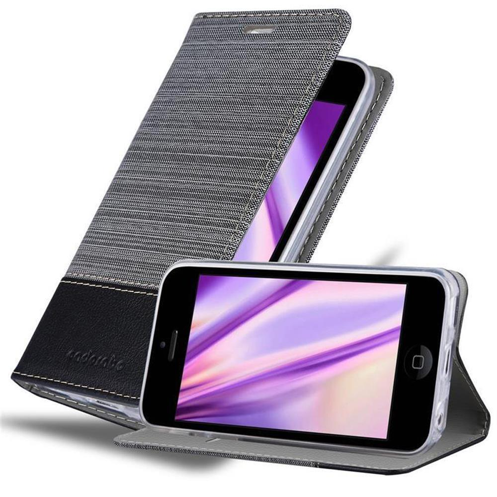 Teléfono en funda gris con detalles negros. Funda abierta. Fondo blanco.