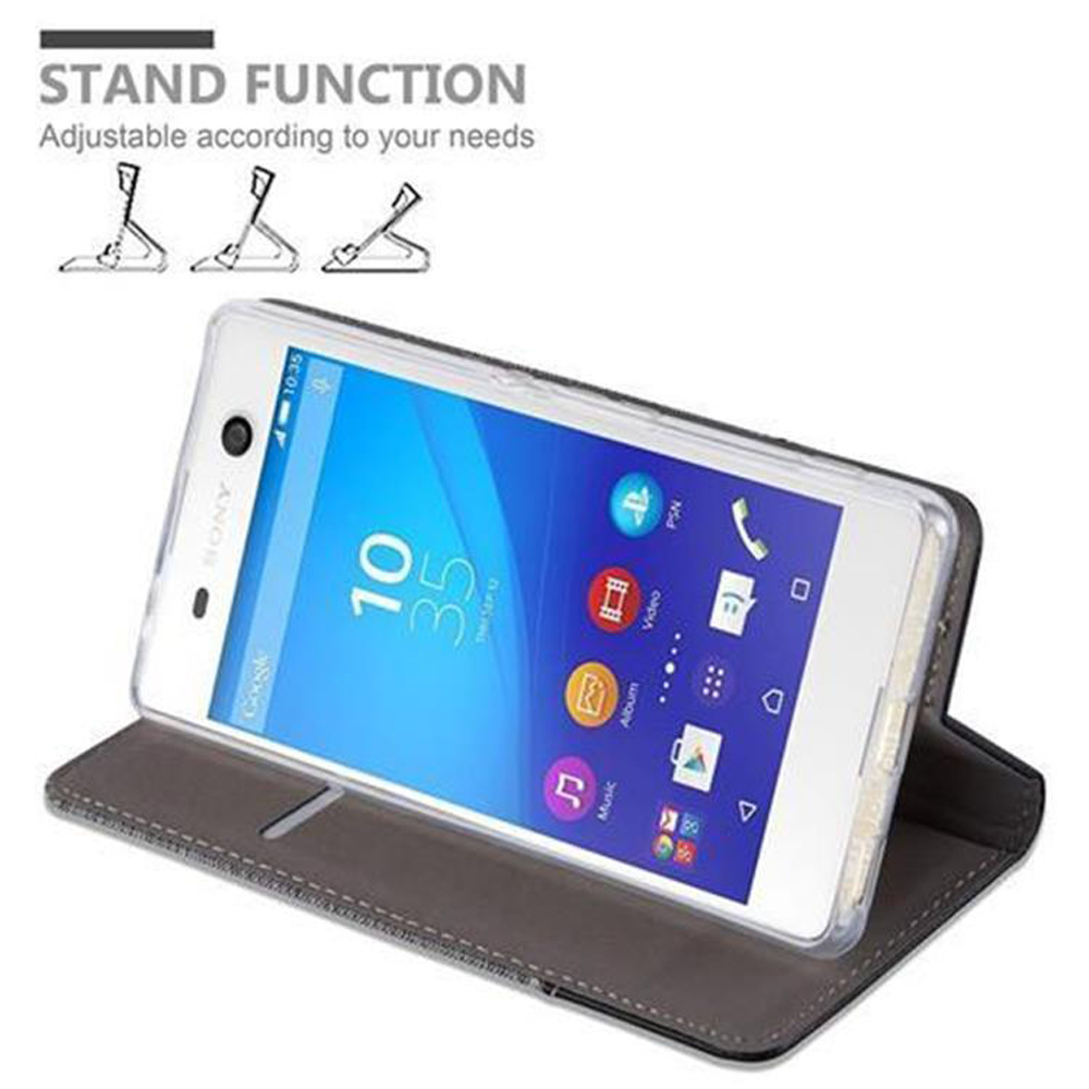 Telefono in custodia, aperto, con funzione stand. Schermo visibile, custodia grigia.