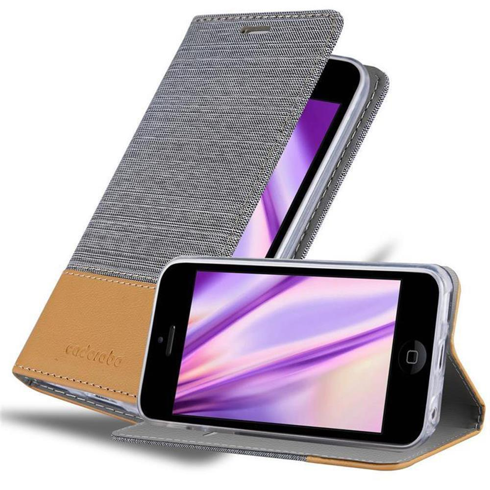 Funda de teléfono con cuero gris y marrón, abierta. El teléfono muestra un patrón púrpura. Otro teléfono en la funda está sobre la mesa.