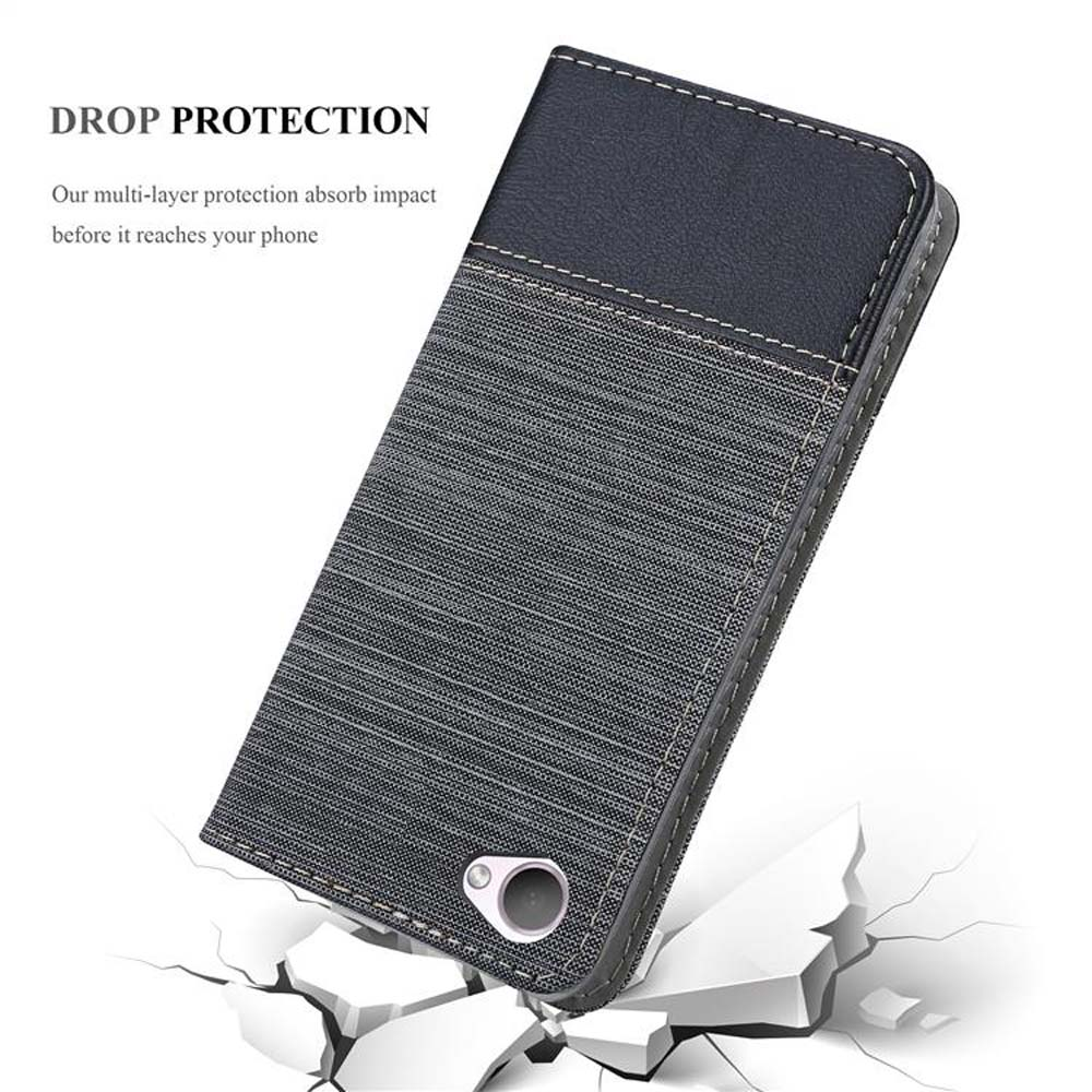 Graues Textil-Handycase mit schwarzem Oberteil. Telefon auf zerbrochener weißer Oberfläche. Text: Fallschutz.