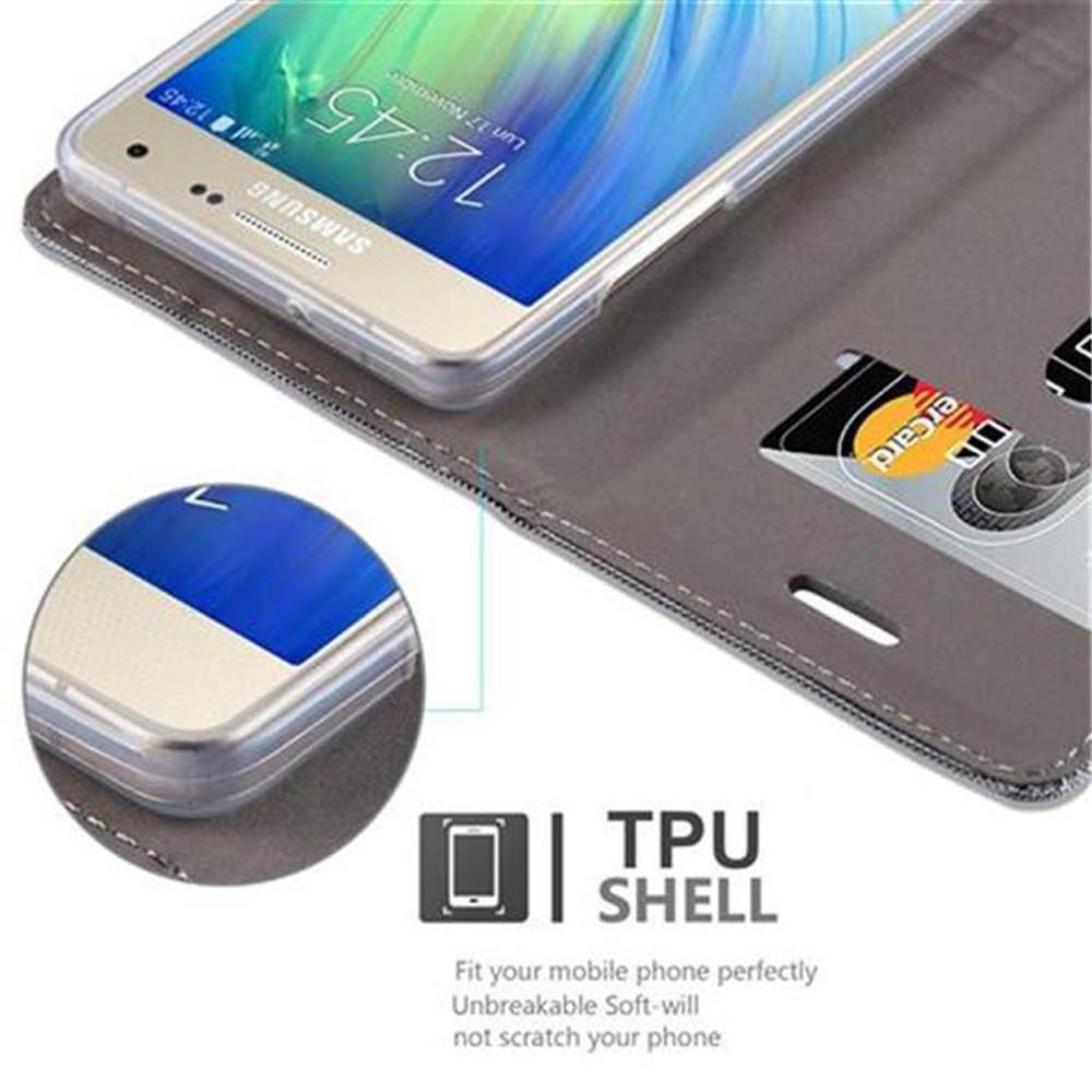 Un telefono in una custodia grigia. Parole chiave: guscio in TPU, vestibilità, infrangibile, non graffia.