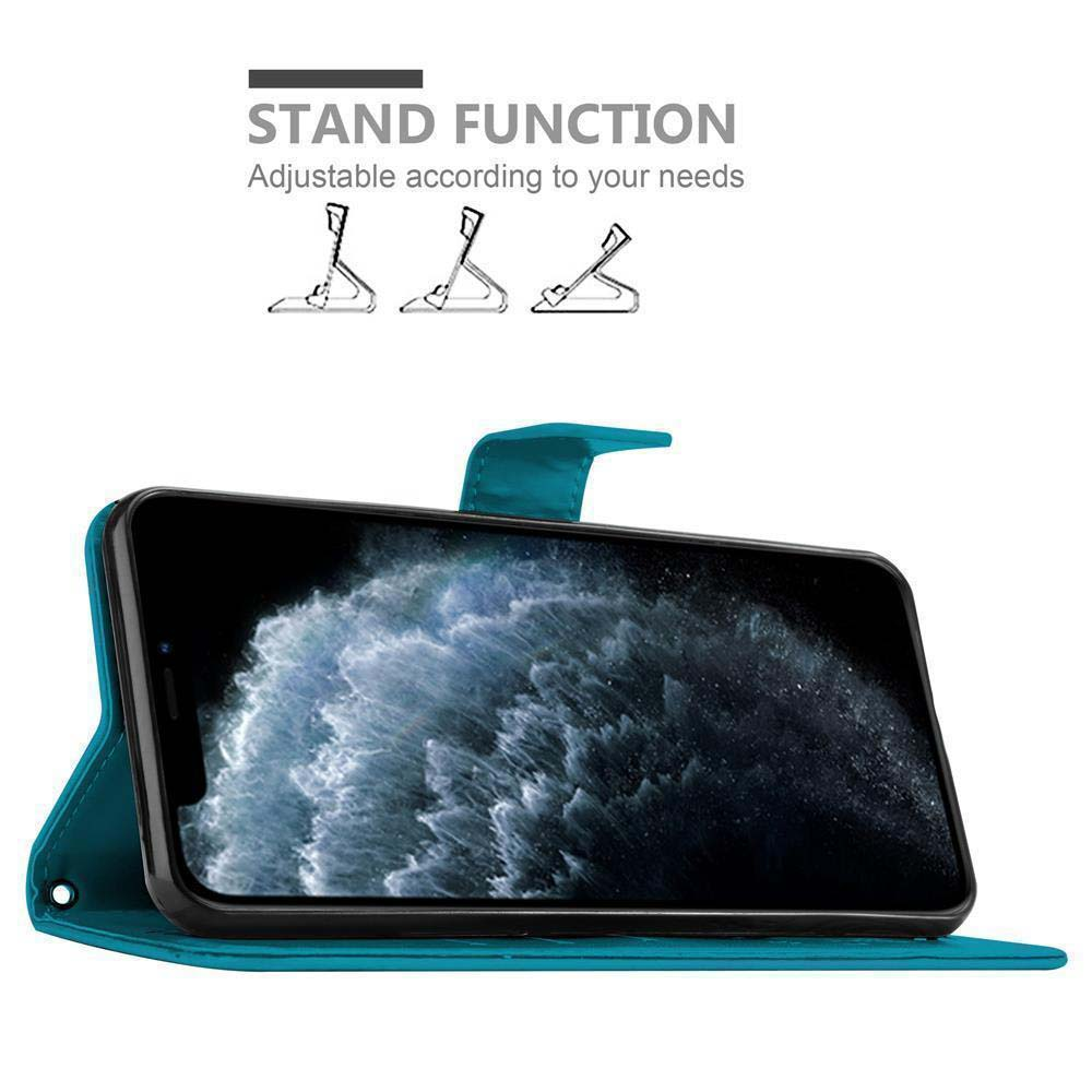 Un telefono nero in una custodia verde acqua. La funzione stand è evidenziata. Il telefono è impostato per la visualizzazione.