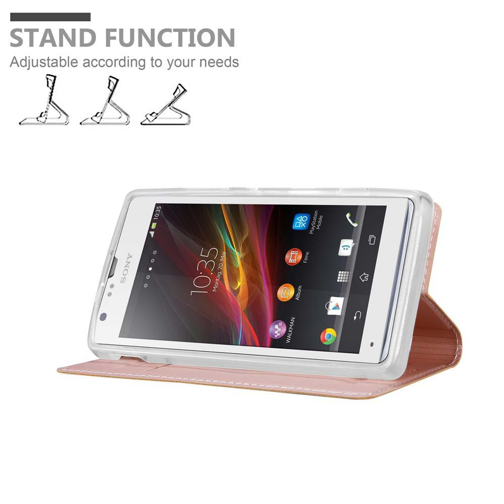 Rosa Handyhülle, hält ein weißes Telefon, steht auf einem Tisch.