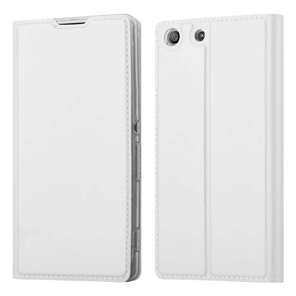 Funda de teléfono blanca; dos fundas, una cerrada, otra abierta. Ambas tienen un agujero para la cámara.