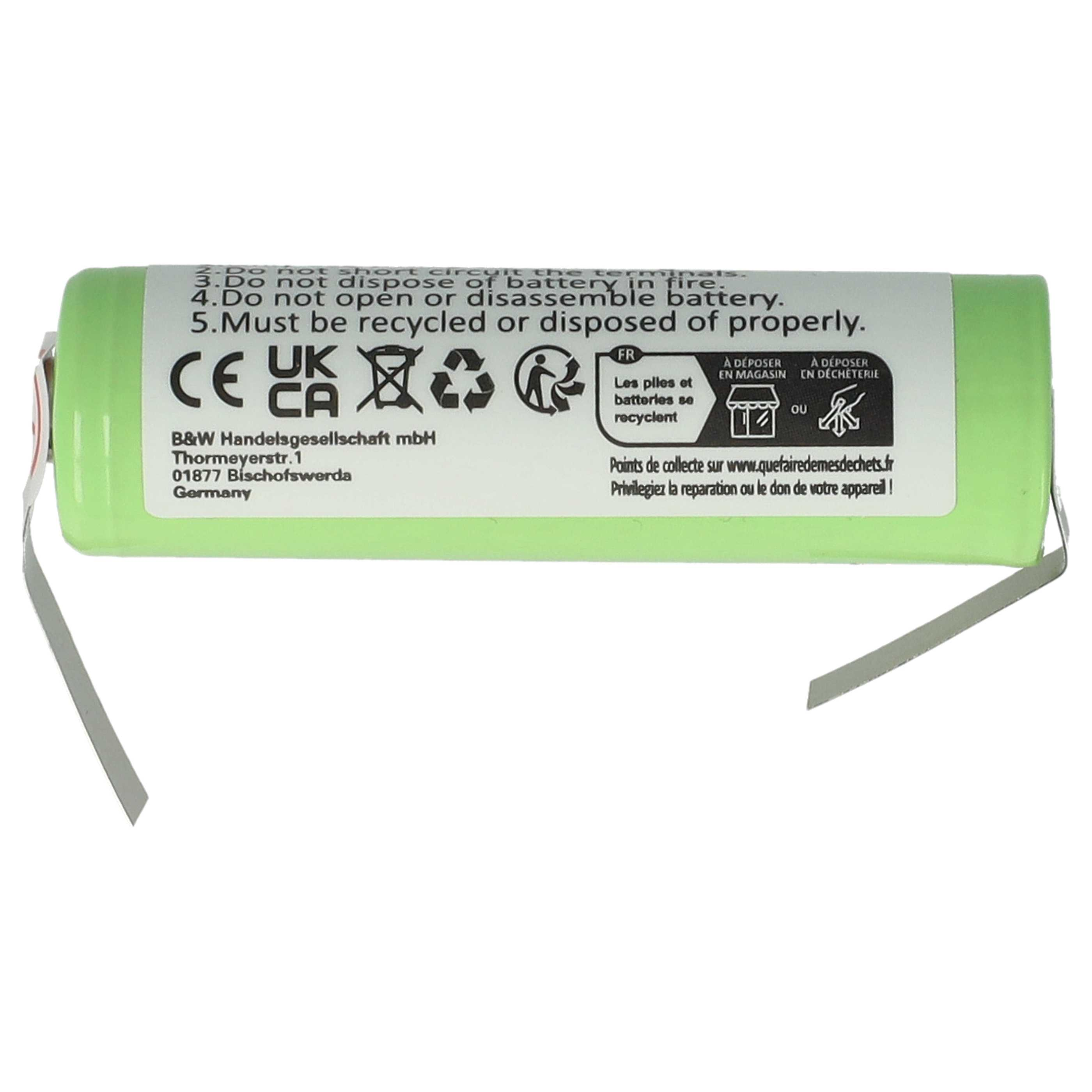 Grüne Batterie mit weißem Etikett. Enthält Warnungen in mehreren Sprachen, darunter Französisch.