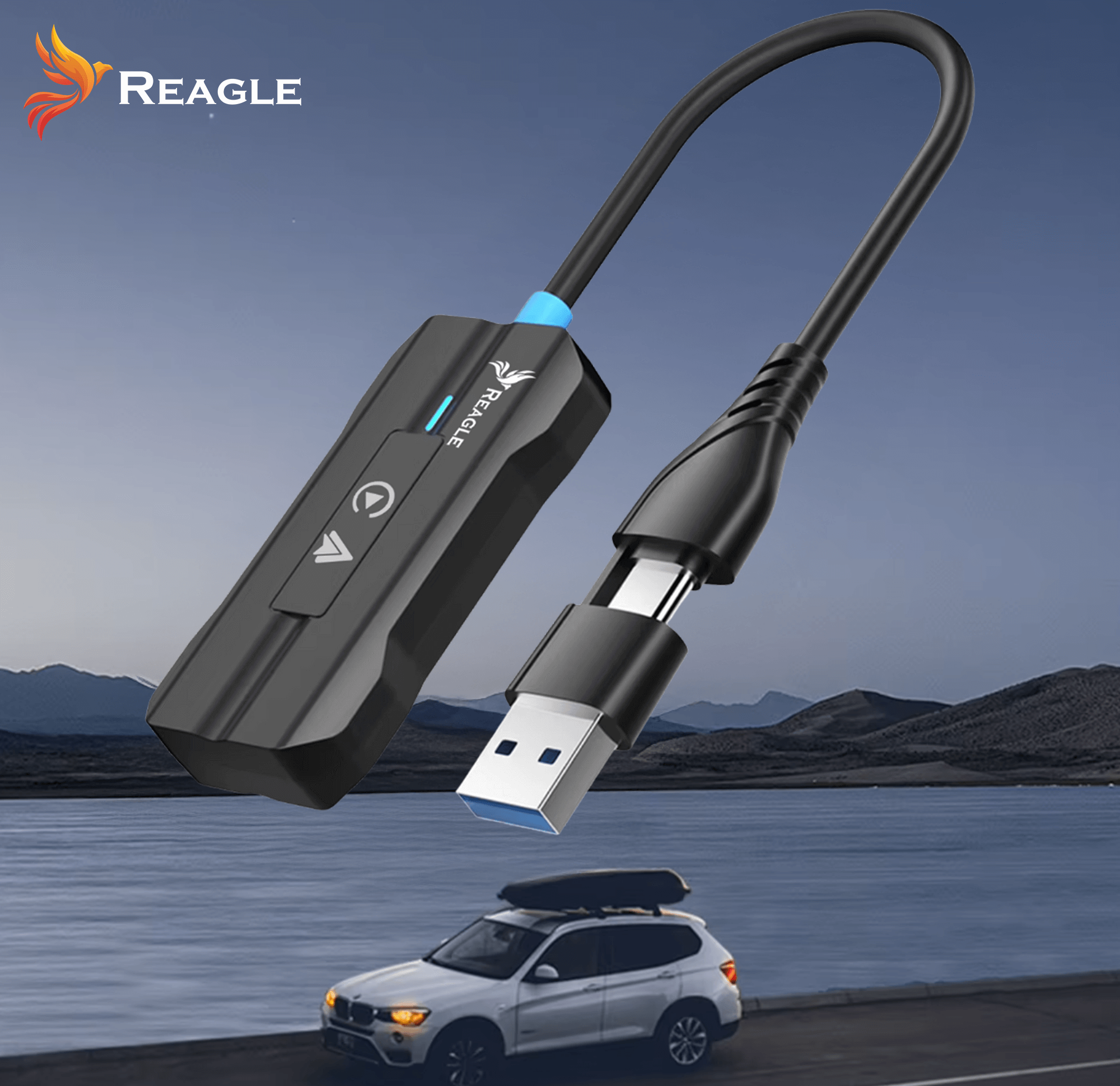Czarny adapter z USB i kablem, logo marki Reagle, na rozmytym tle krajobrazu z samochodem.