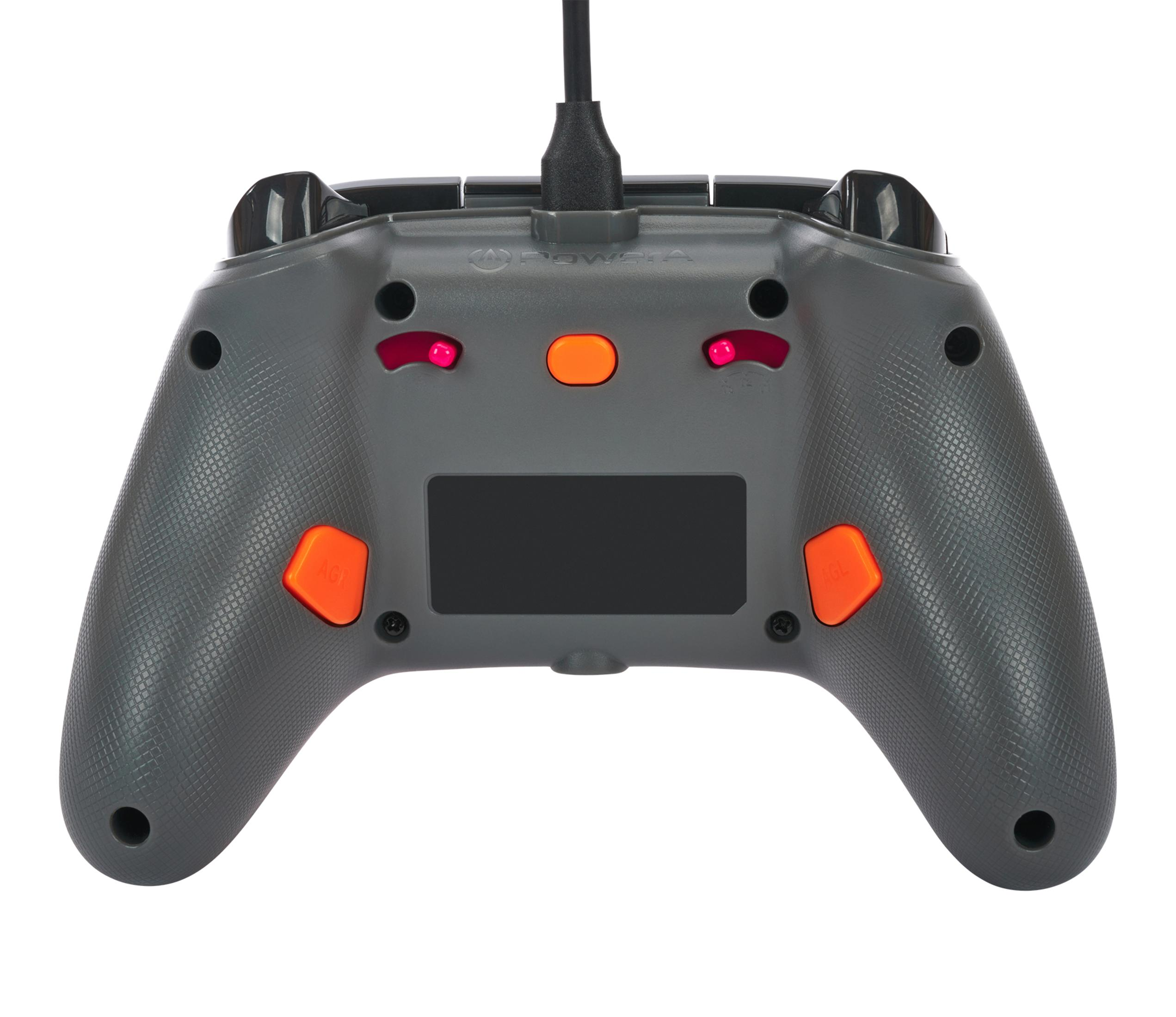 Szary kontroler gamepada z pomarańczowymi przyciskami i czarną górą.