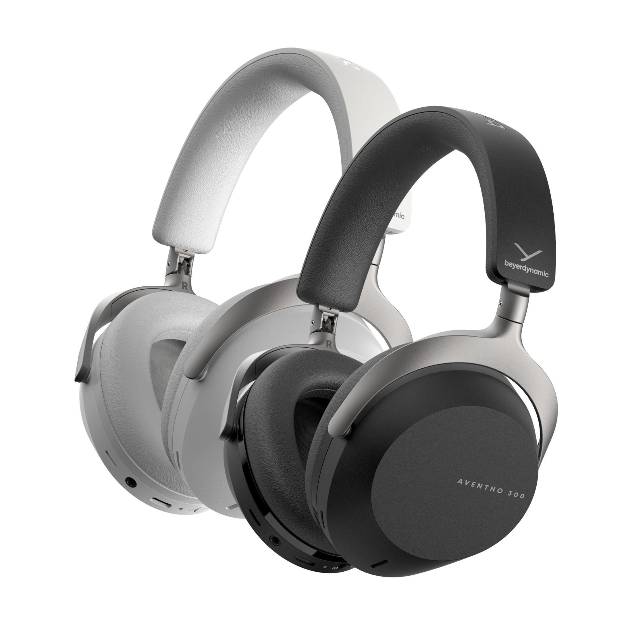Due cuffie over-ear, una bianca e una nera, su sfondo bianco.