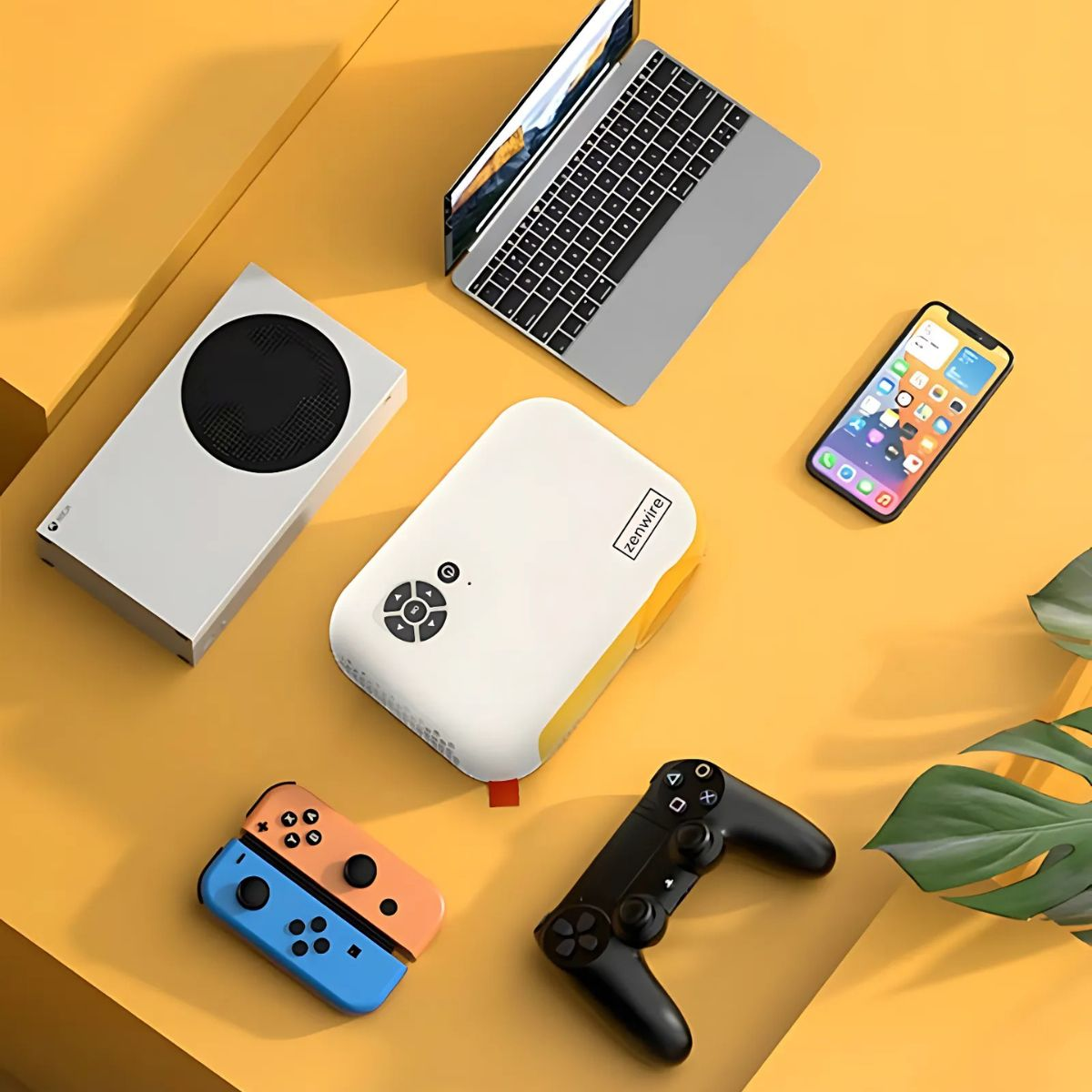Zestaw elektroniki: laptop, telefon, konsola do gier, kontroler i projektor.