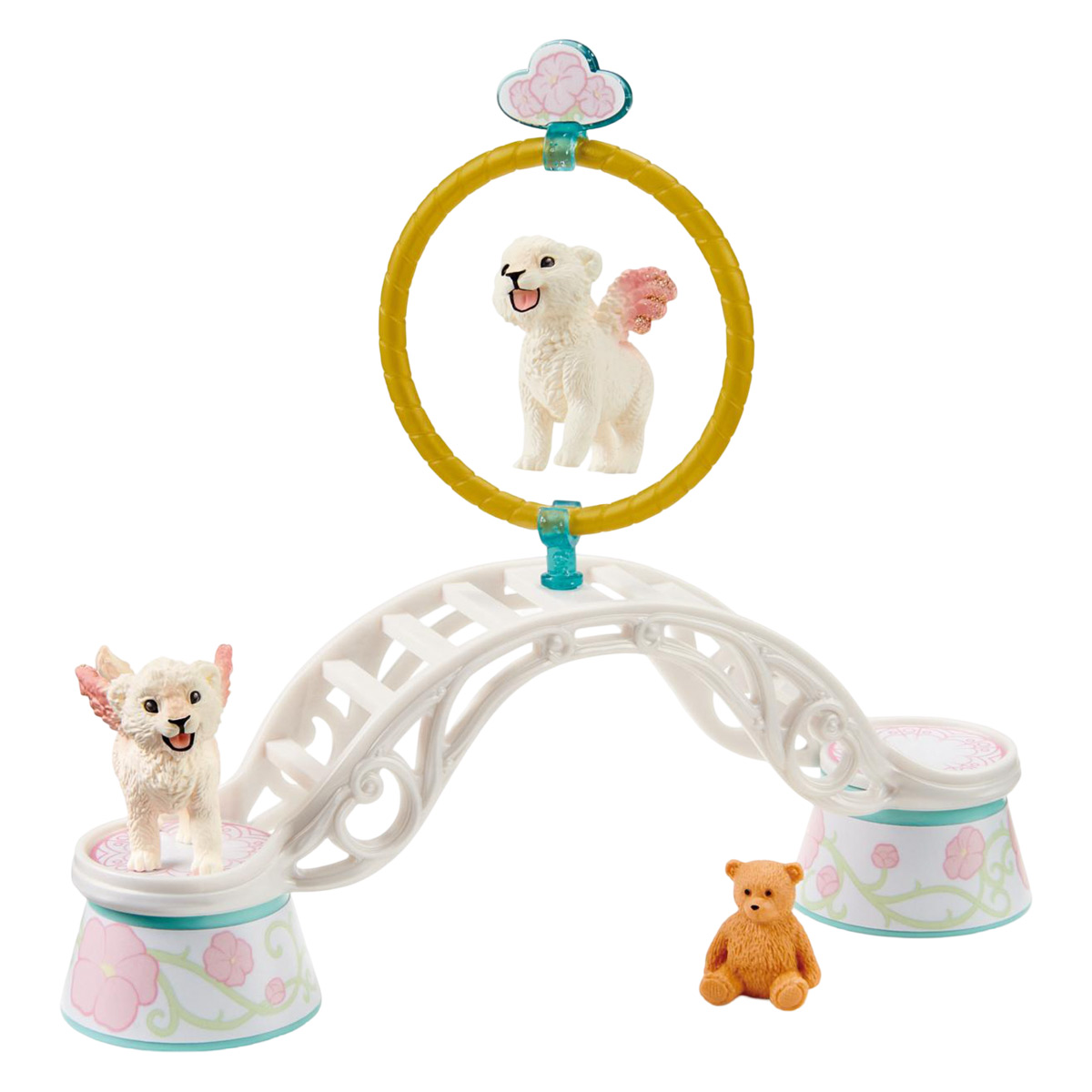 Set di giocattoli con due cani alati. Un anello giallo, un ponte bianco e un orsacchiotto. Sfondo bianco.