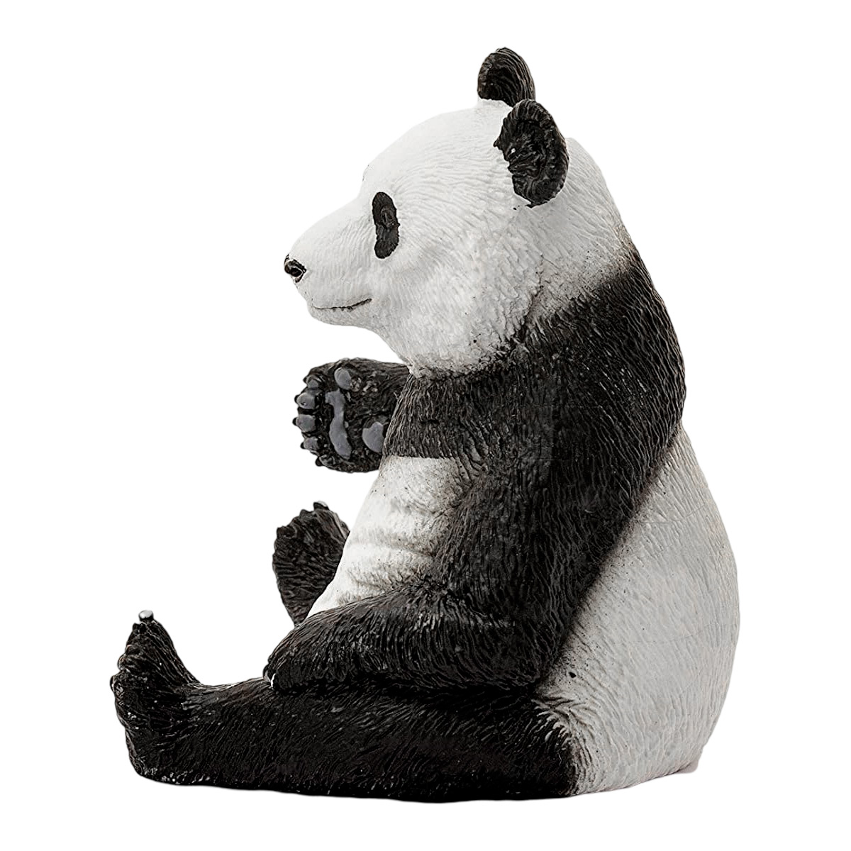 Panda-Figur sitzt, schwarz-weißes Fell. Es schaut nach links, hält die Pfoten hoch.