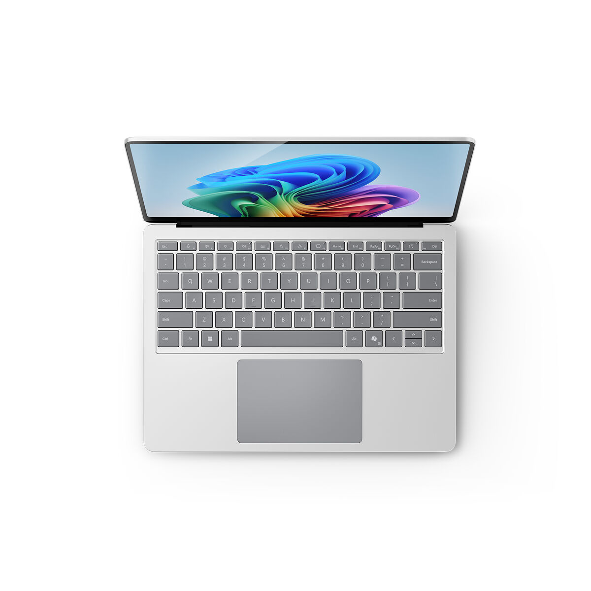 Otwarty laptop, pokazujący kolorowy, abstrakcyjny obraz na ekranie. Białe tło.