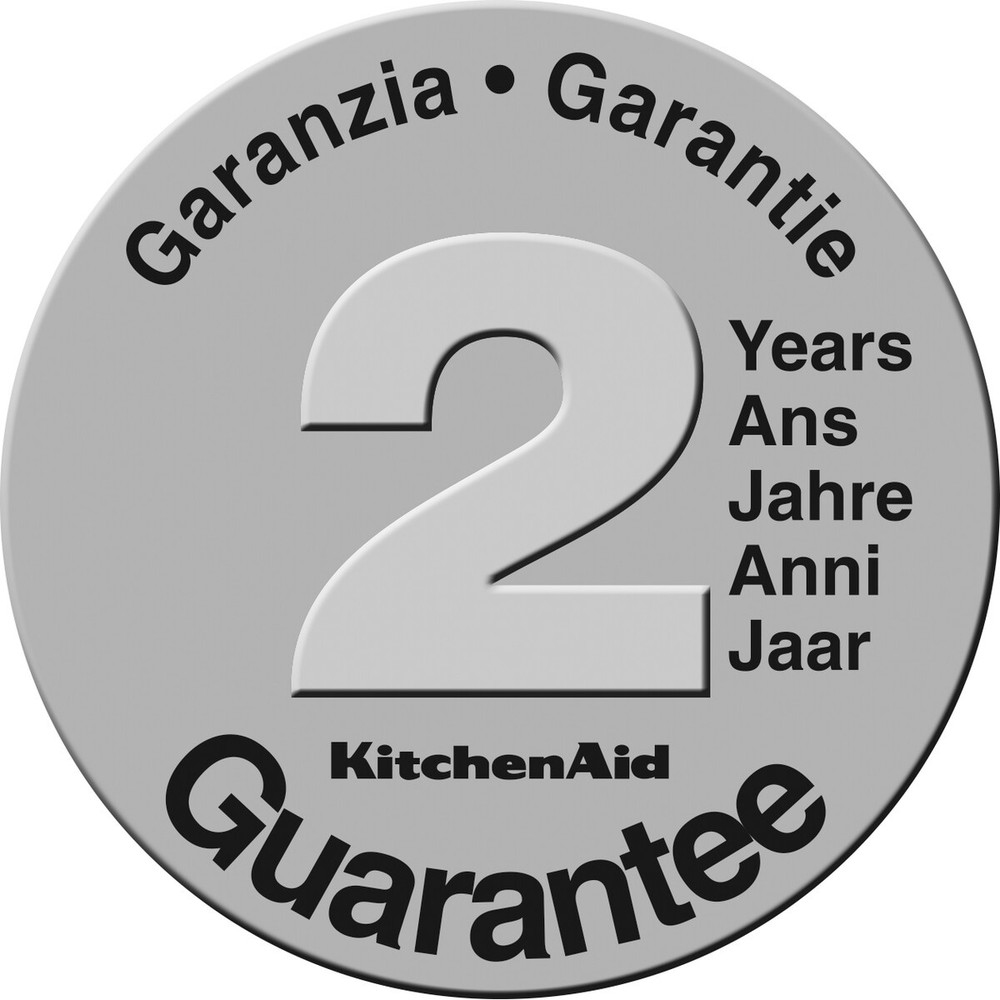 Srebrna odznaka gwarancyjna KitchenAid z dużą białą '2' i tekstem w wielu językach.