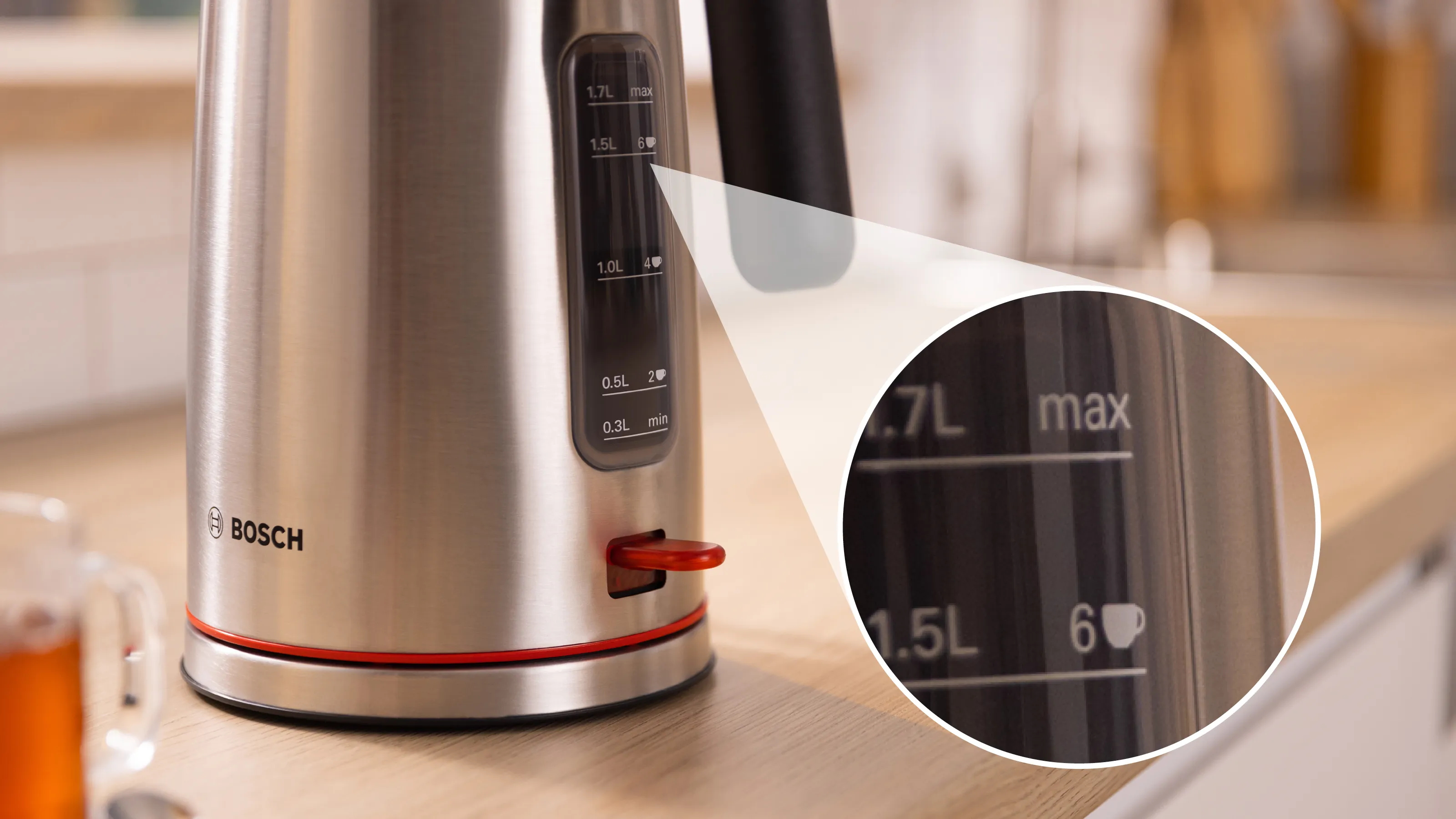 Stainless steel electric kettle with red accents. A close-up shows water level indicators and capacity markings.