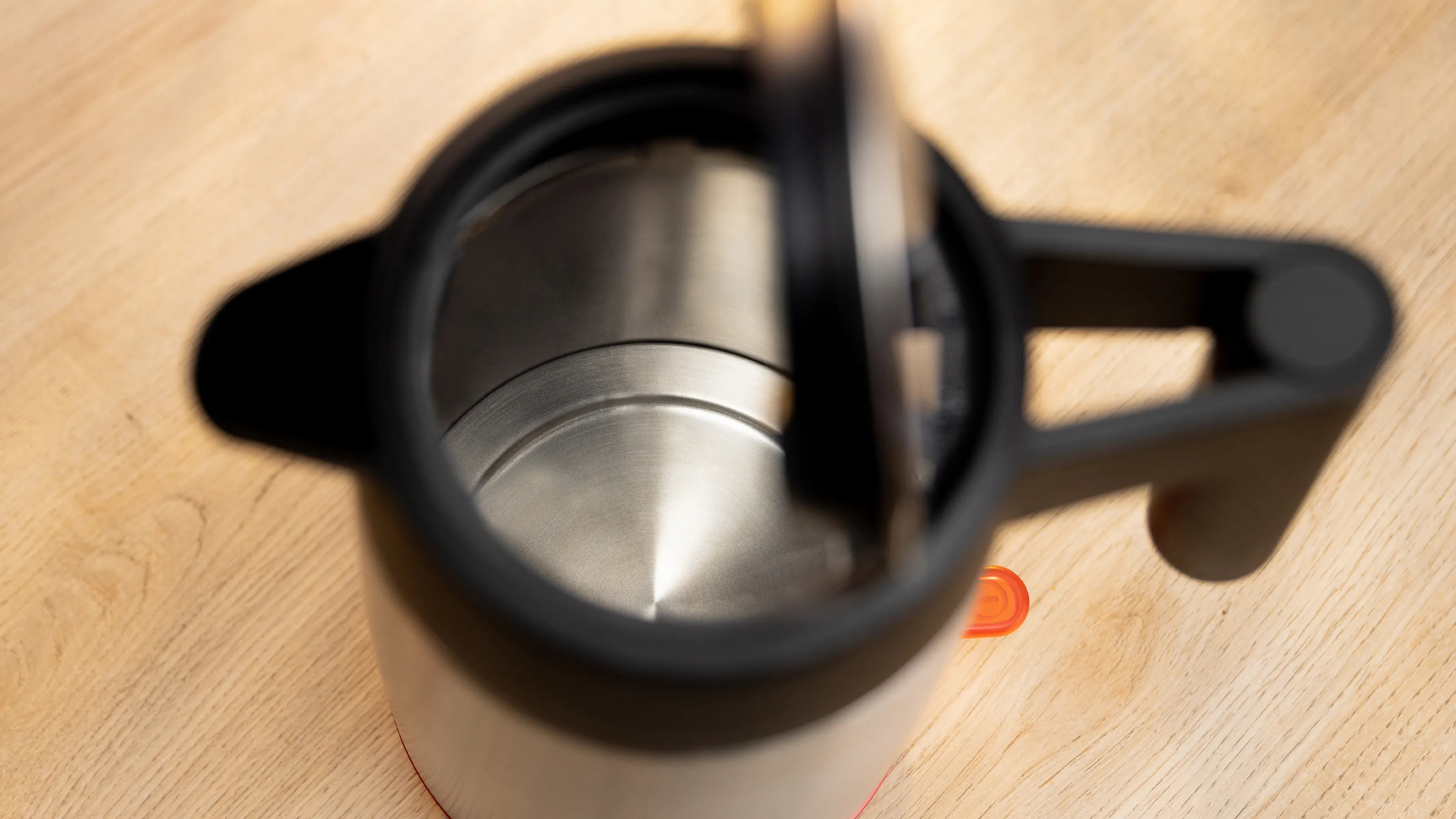 Top view of a kettle with an open lid, with a stainless steel interior.