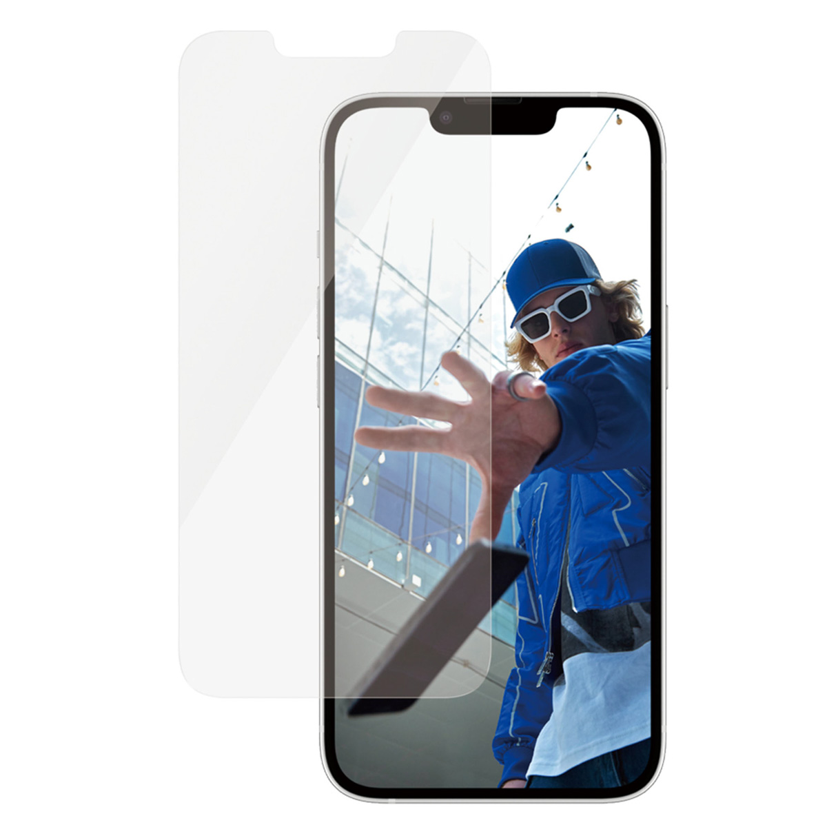 Een telefoon met een schermbeschermer, met een persoon op de achtergrond.