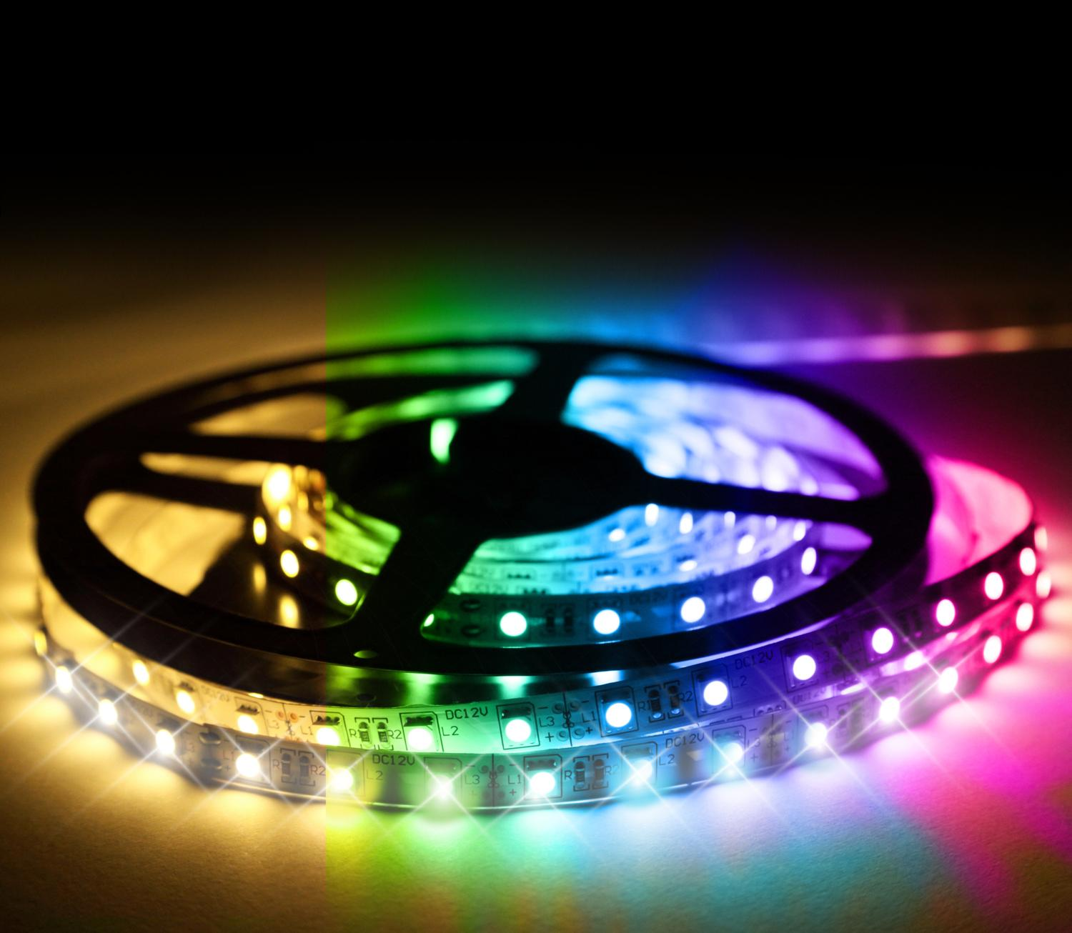 A roll of LED light strips with various colors lit up. The background is dark.