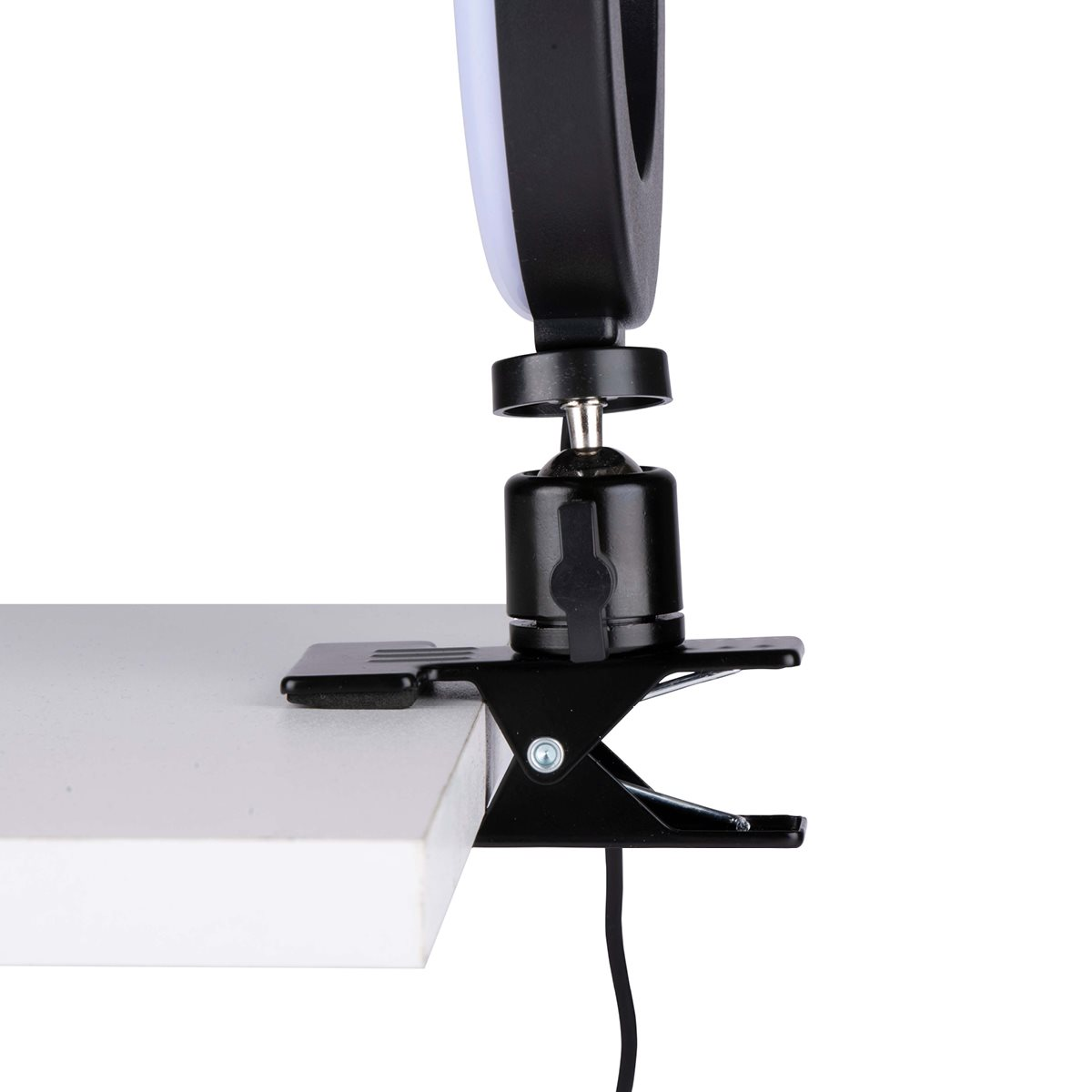 Une pince noire tenant une lumière noire et blanche. La pince est sur une surface blanche.