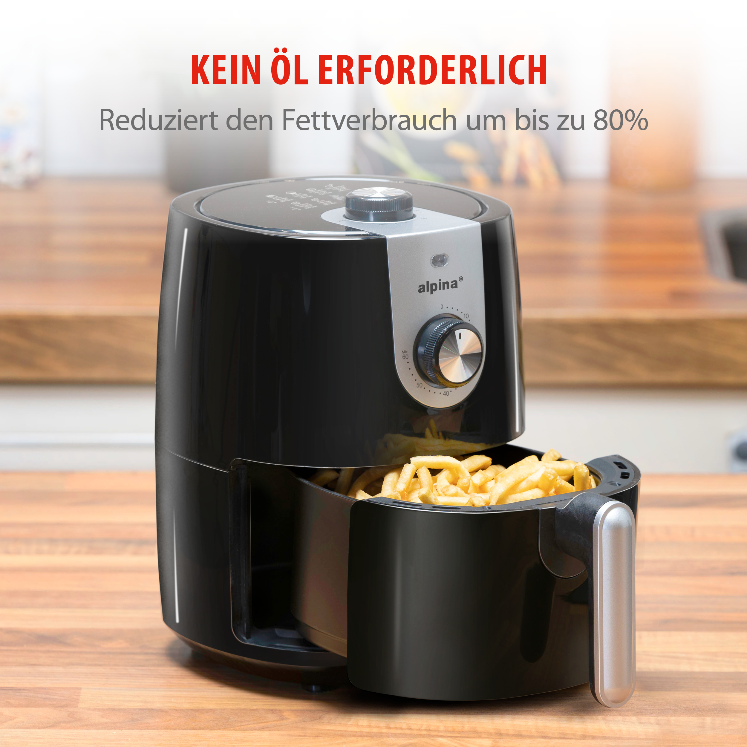 Zwarte heteluchtfriteuse met een mandje friet. Er staat Kein Öl Erforderlich en vermindert het vetverbruik tot 80%.
