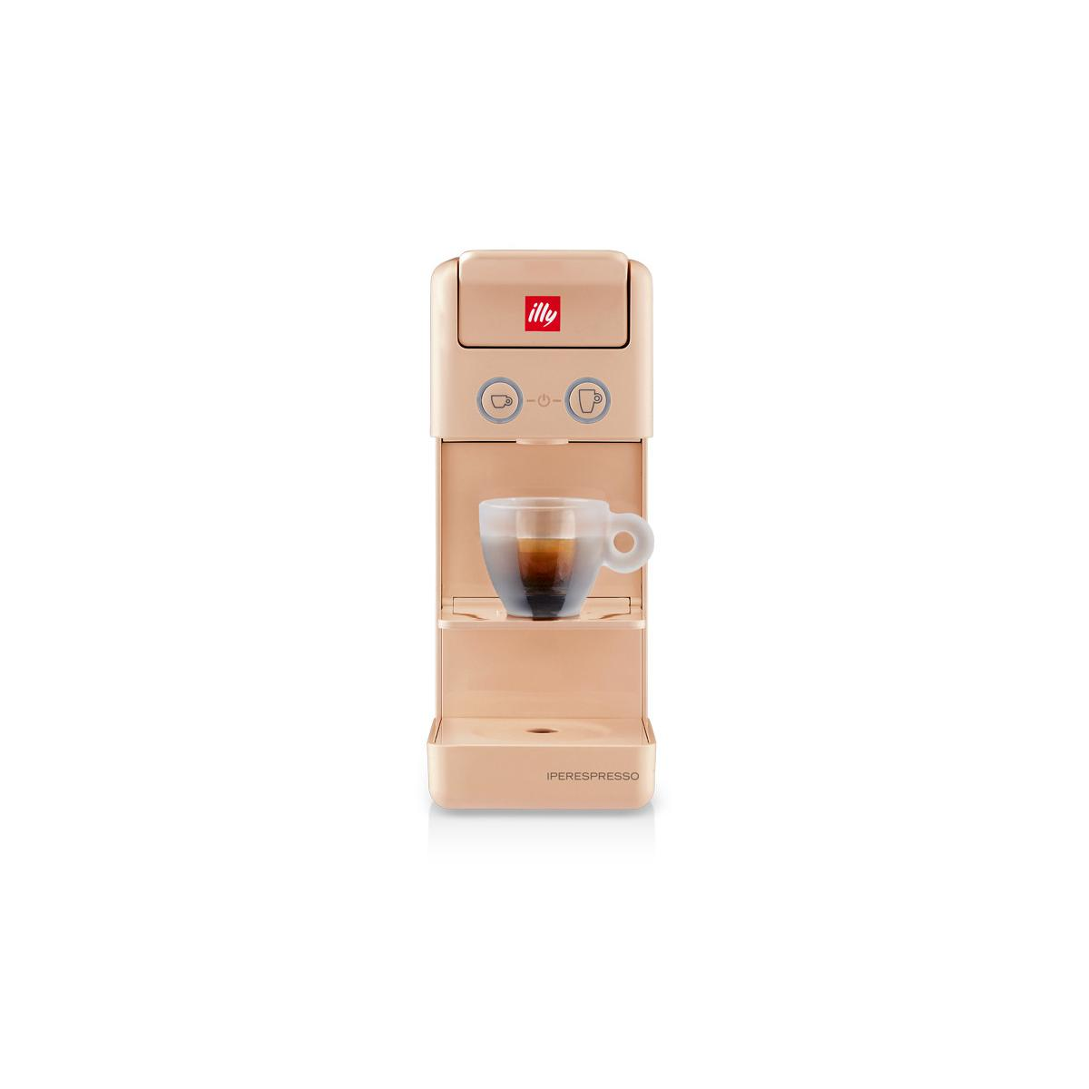 Una macchina per caffè Illy Iperespresso beige, con una tazza di caffè. Ha due pulsanti e un vassoio.