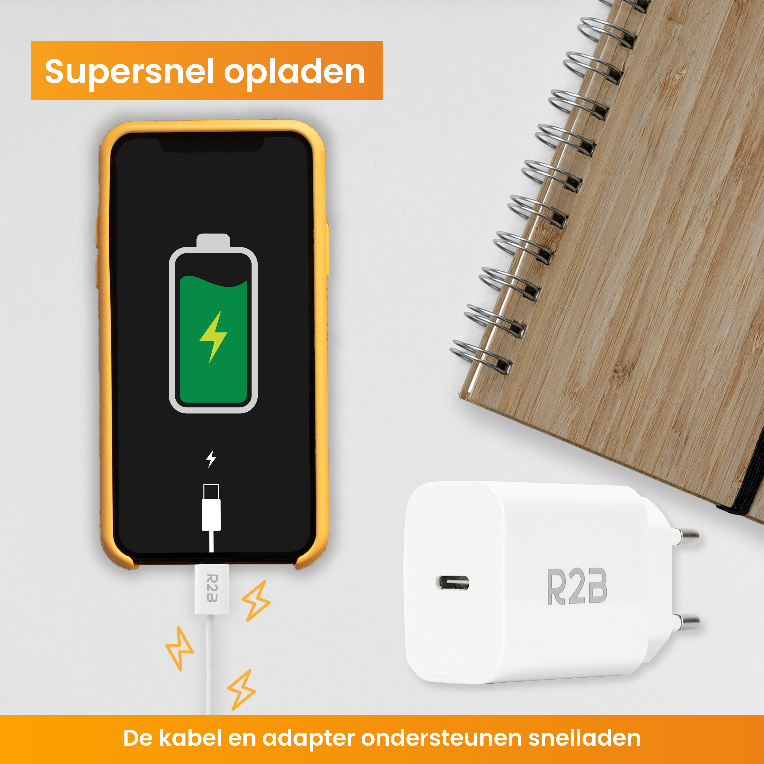 Ein Telefon, das mit einem weißen Ladegerät, Kabel und einem Notizbuch auf gelbem Hintergrund geladen wird.