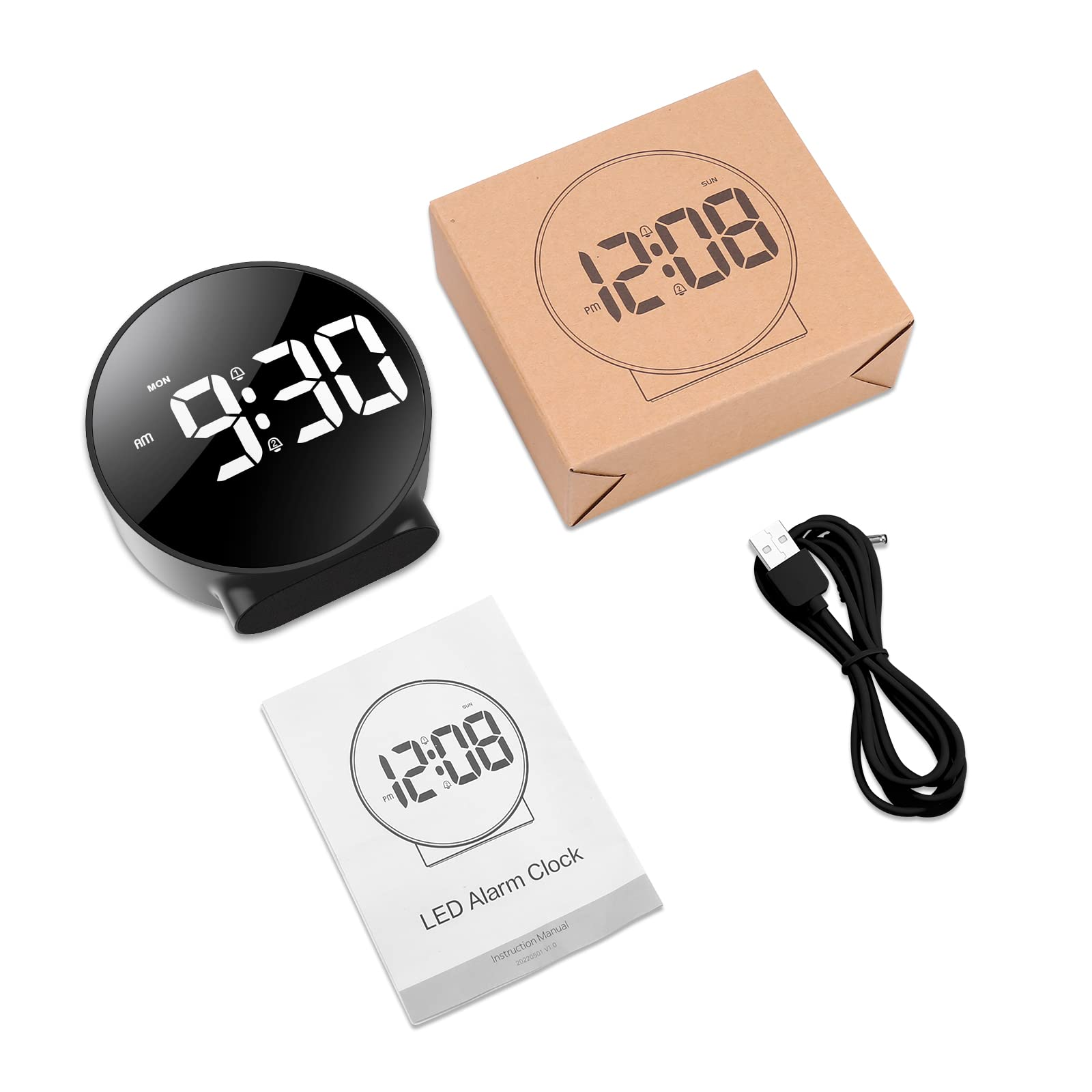 Schwarzer Wecker, Bedienungsanleitung, USB-Kabel und eine Box. Die Uhr zeigt 9:30.