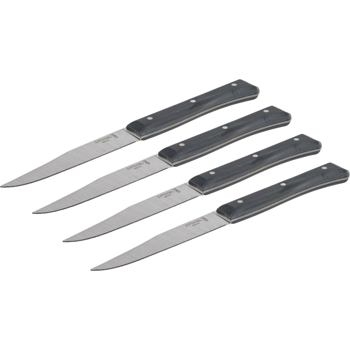 Vier Opinel Steakmesser auf weißer Oberfläche. Sie haben schwarze Griffe und silberne Klingen.