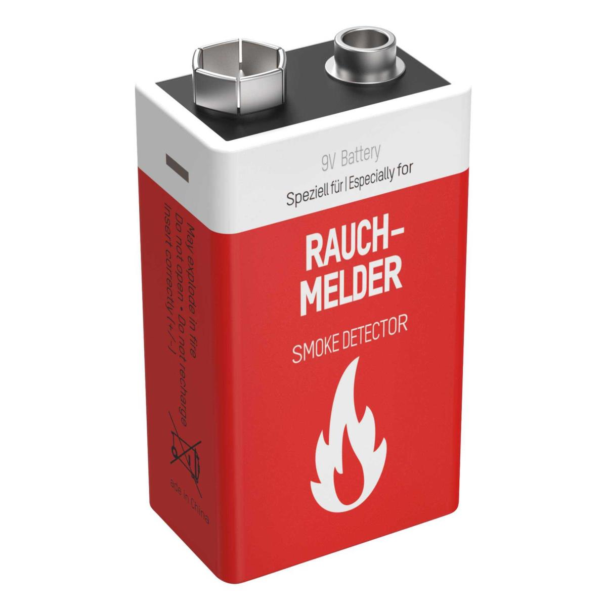 Een rode en witte 9V-rookmelderbatterij met veiligheidswaarschuwingen erop gedrukt.