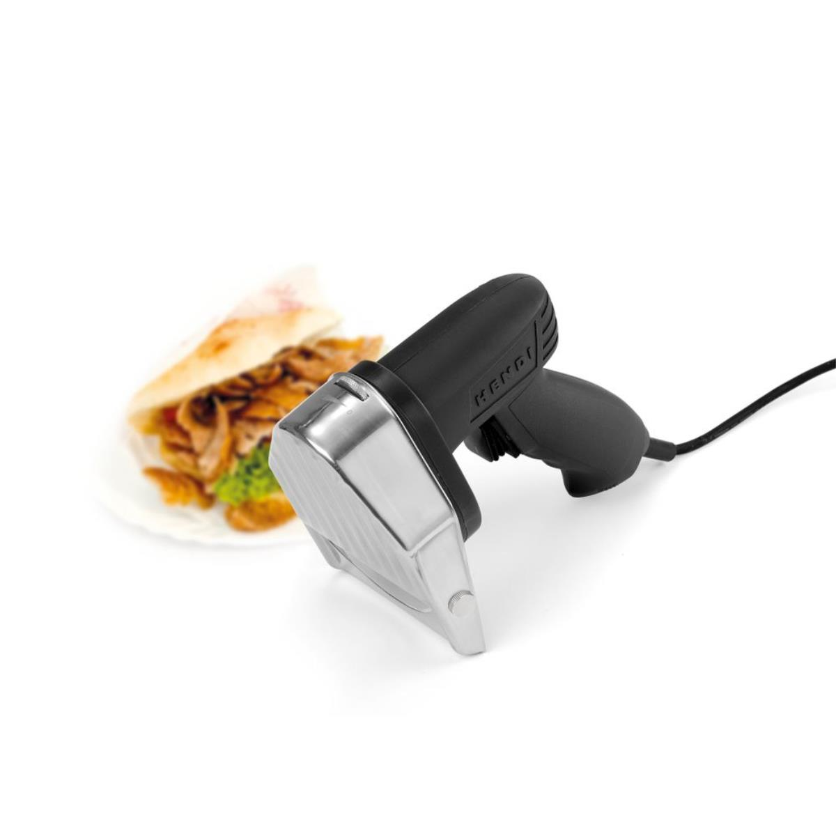Coltello gyro nero con shawarma e pane sullo sfondo.