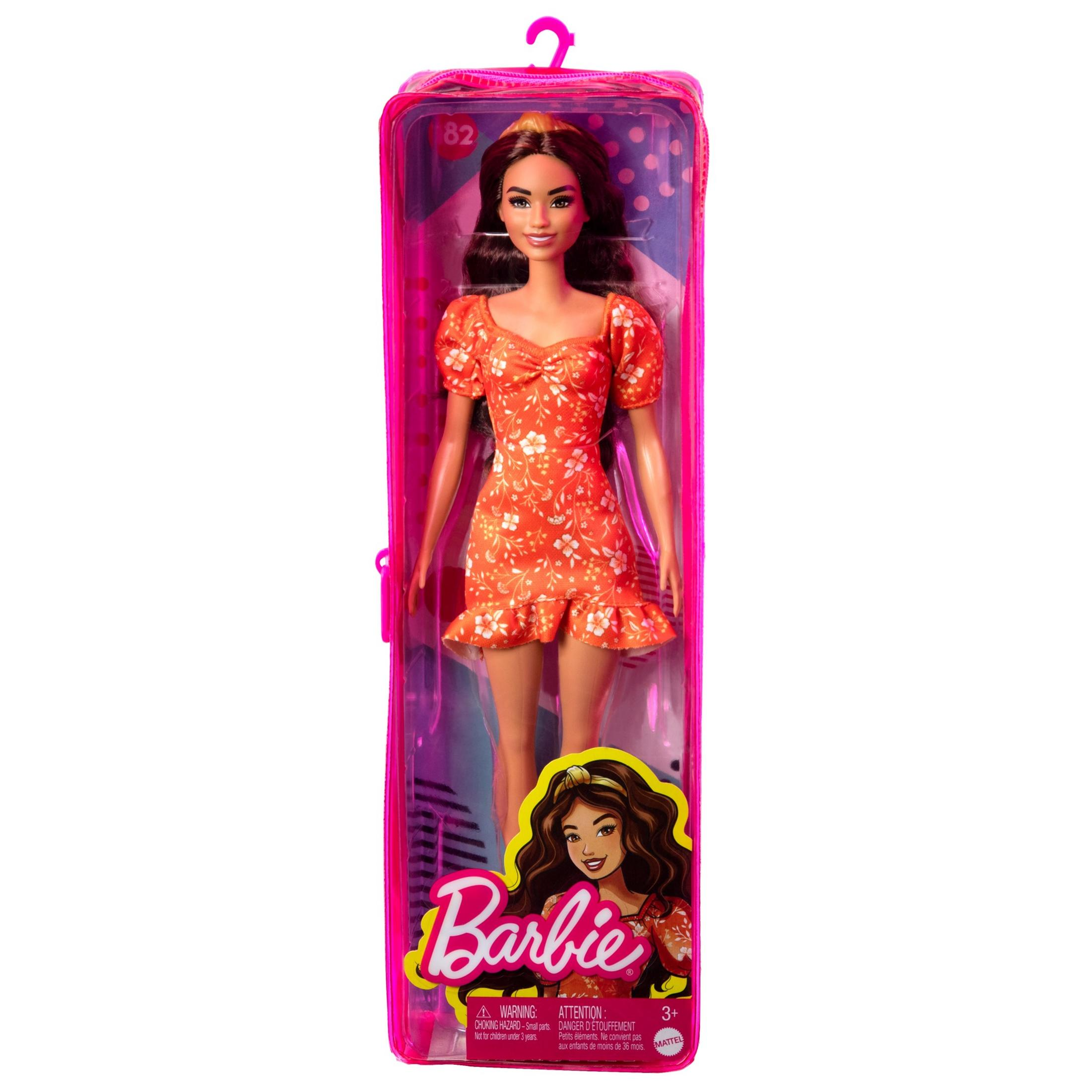 Eine Barbie-Puppe in einer Box, die ein orangefarbenes Blumenkleid trägt.