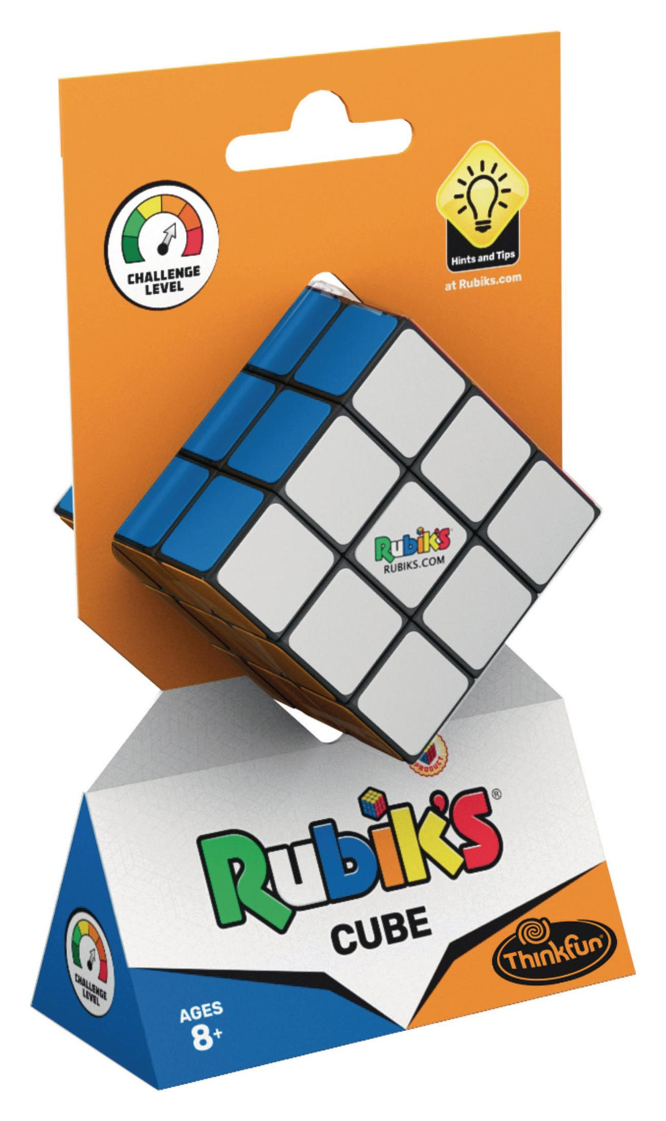 Rubik's Cube in Verpackung: Weiß, blau und braun. Verpackung ist orange und weiß, mit Text und Bildern.