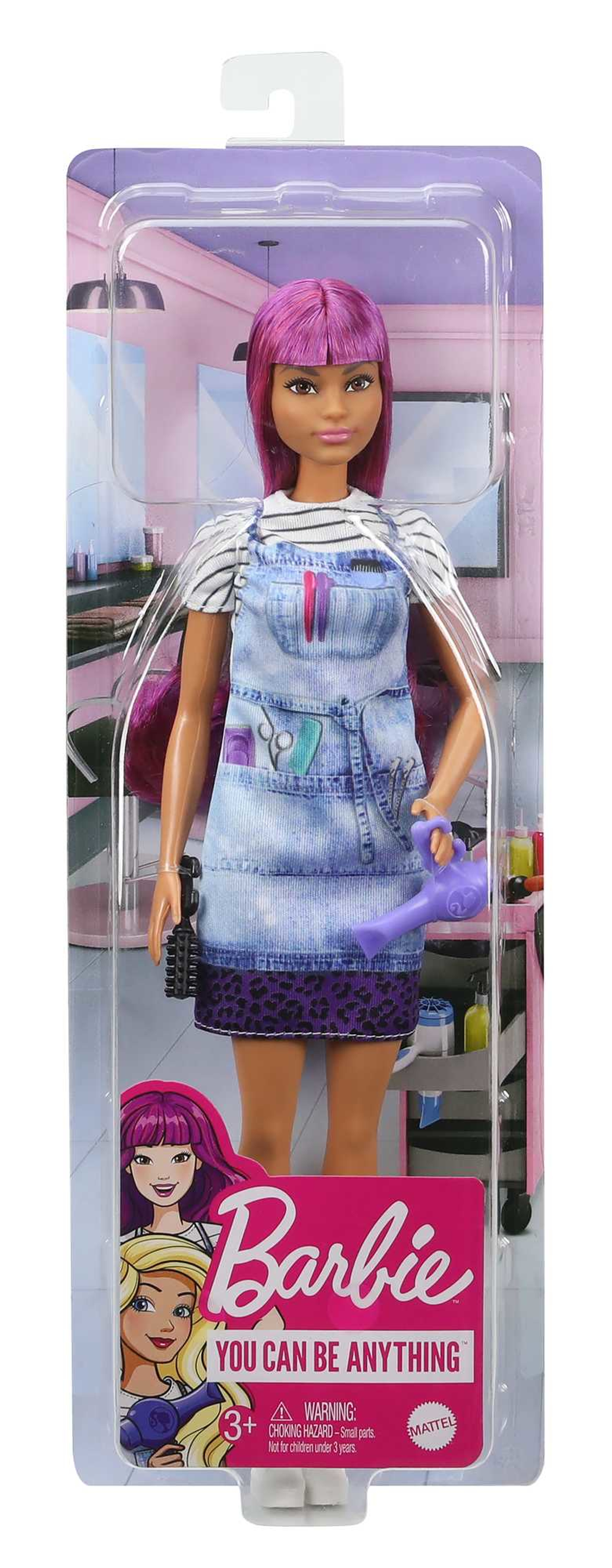 Barbie-Puppe in einer Box. Sie ist Friseurin, trägt eine Schürze und hält einen Haartrockner.
