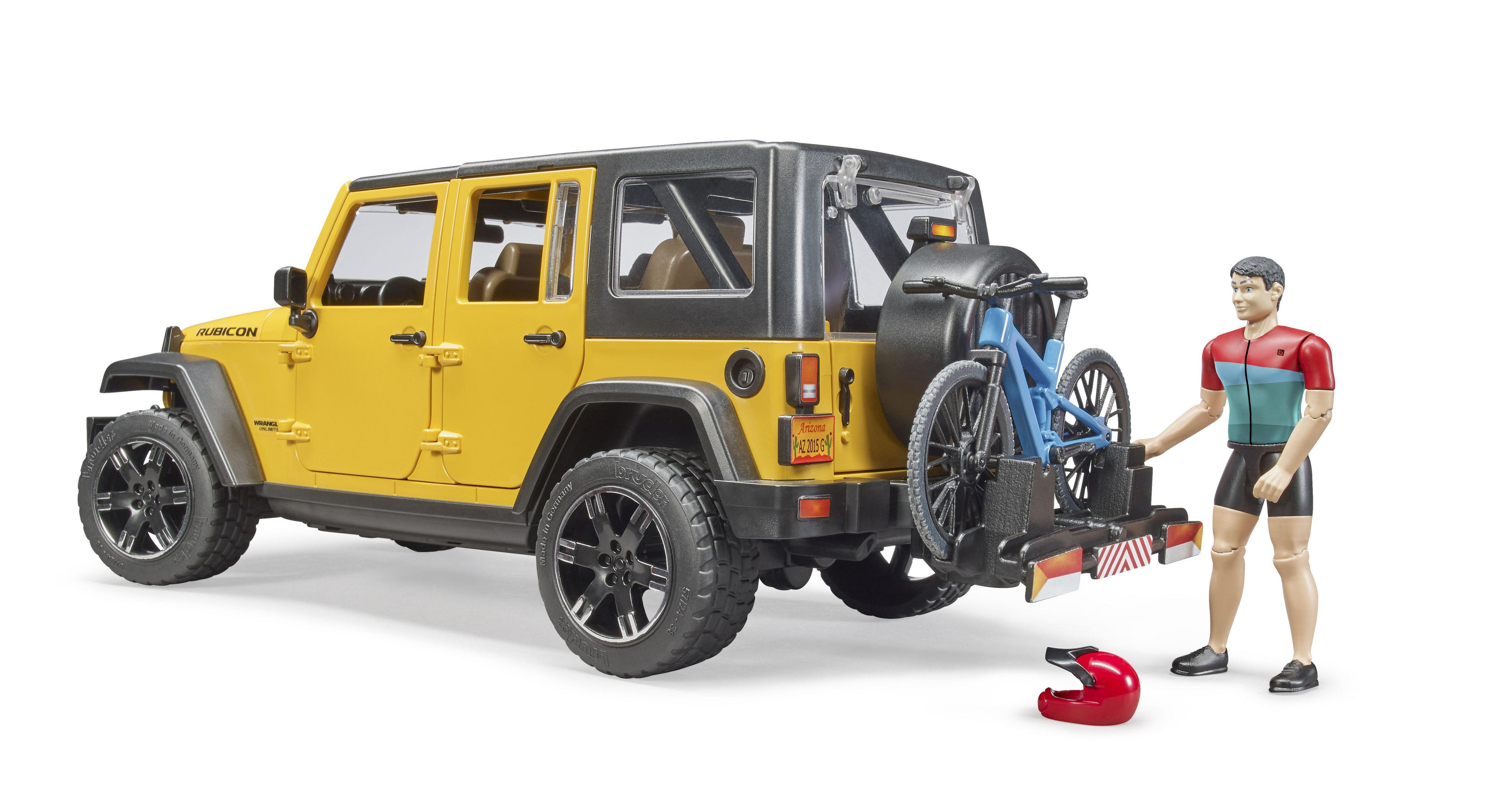 Gelber Jeep Wrangler mit Fahrradträger, Person und Helm am Boden.