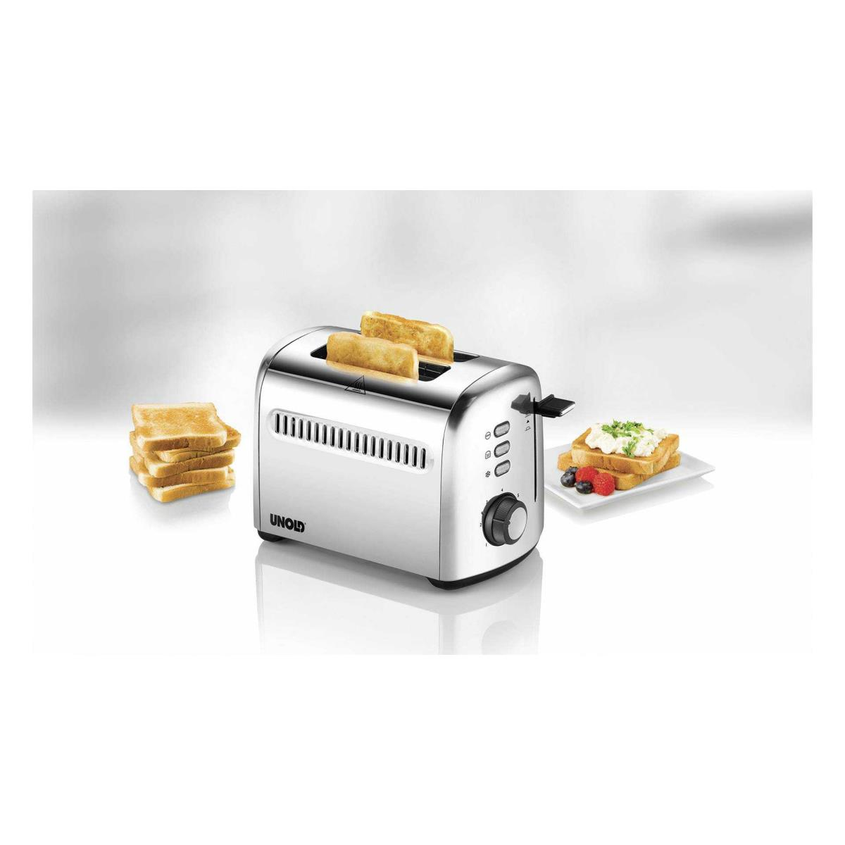 Srebrny toster z kromkami chleba. Tost na talerzu. Kilka kromek chleba z boku.