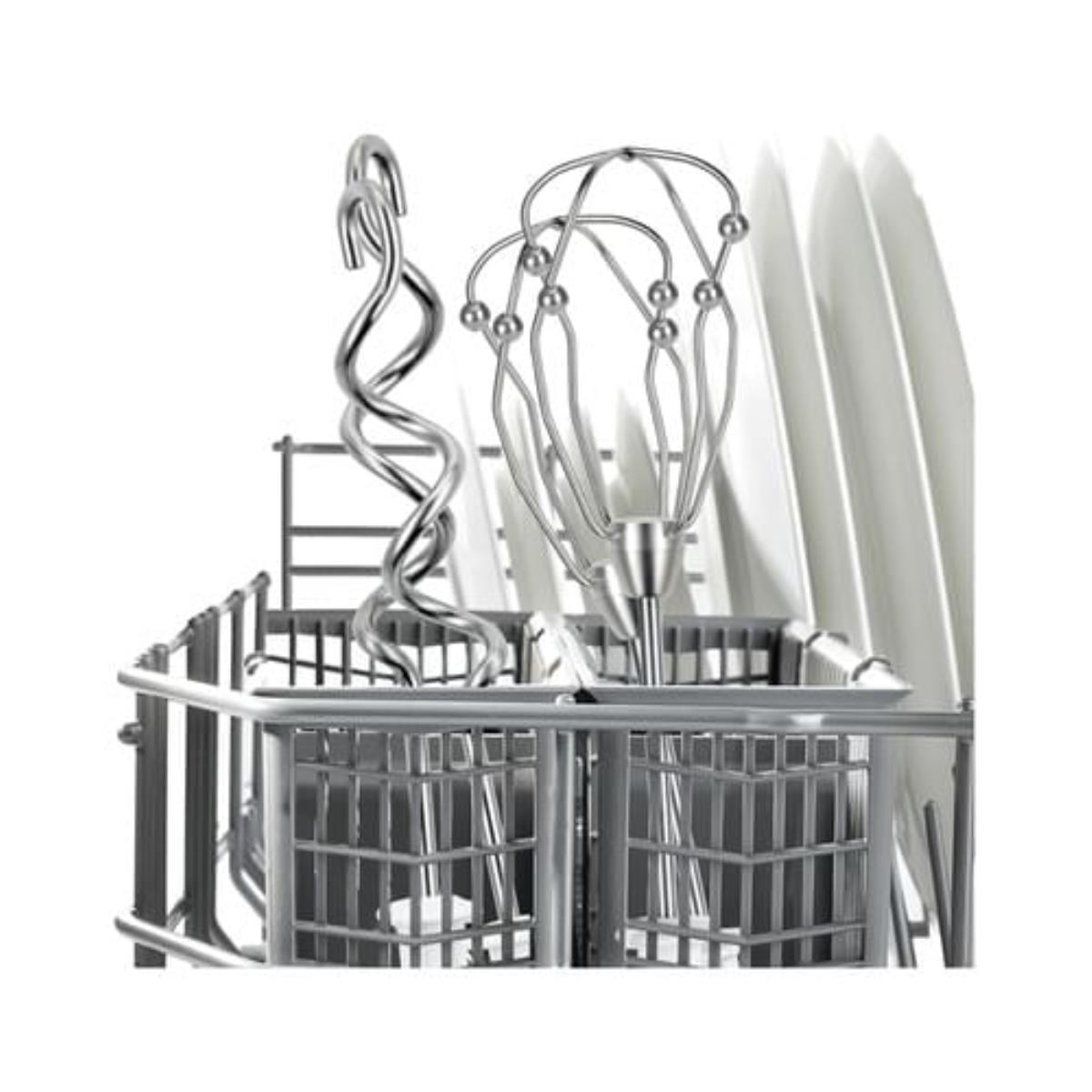 Close-up of a dishwasher basket with utensils, including a whisk and plates, against white.