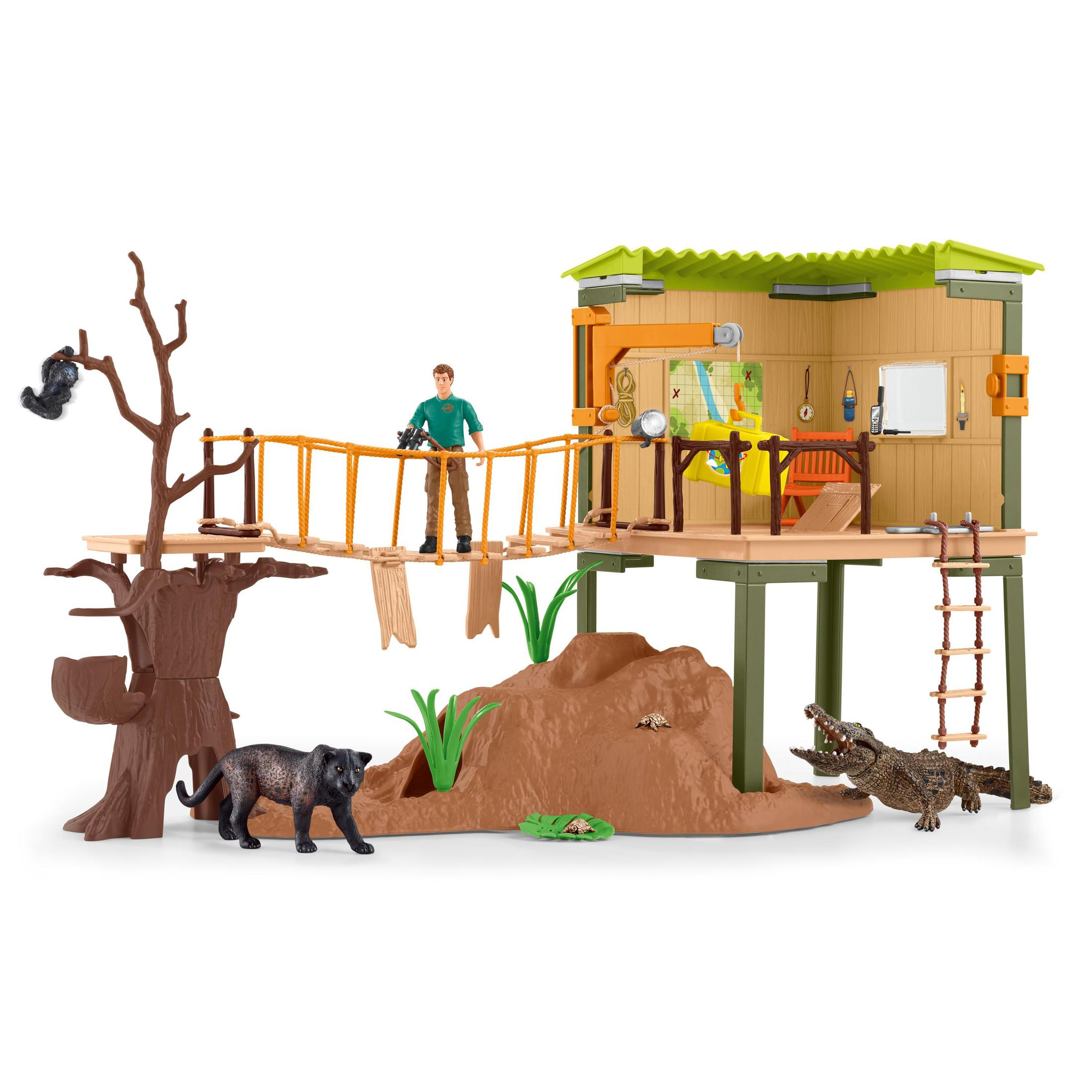 Ein Spielzeug-Zoo-Set mit Baumhaus, Tieren und einem Mann mit Fernglas.