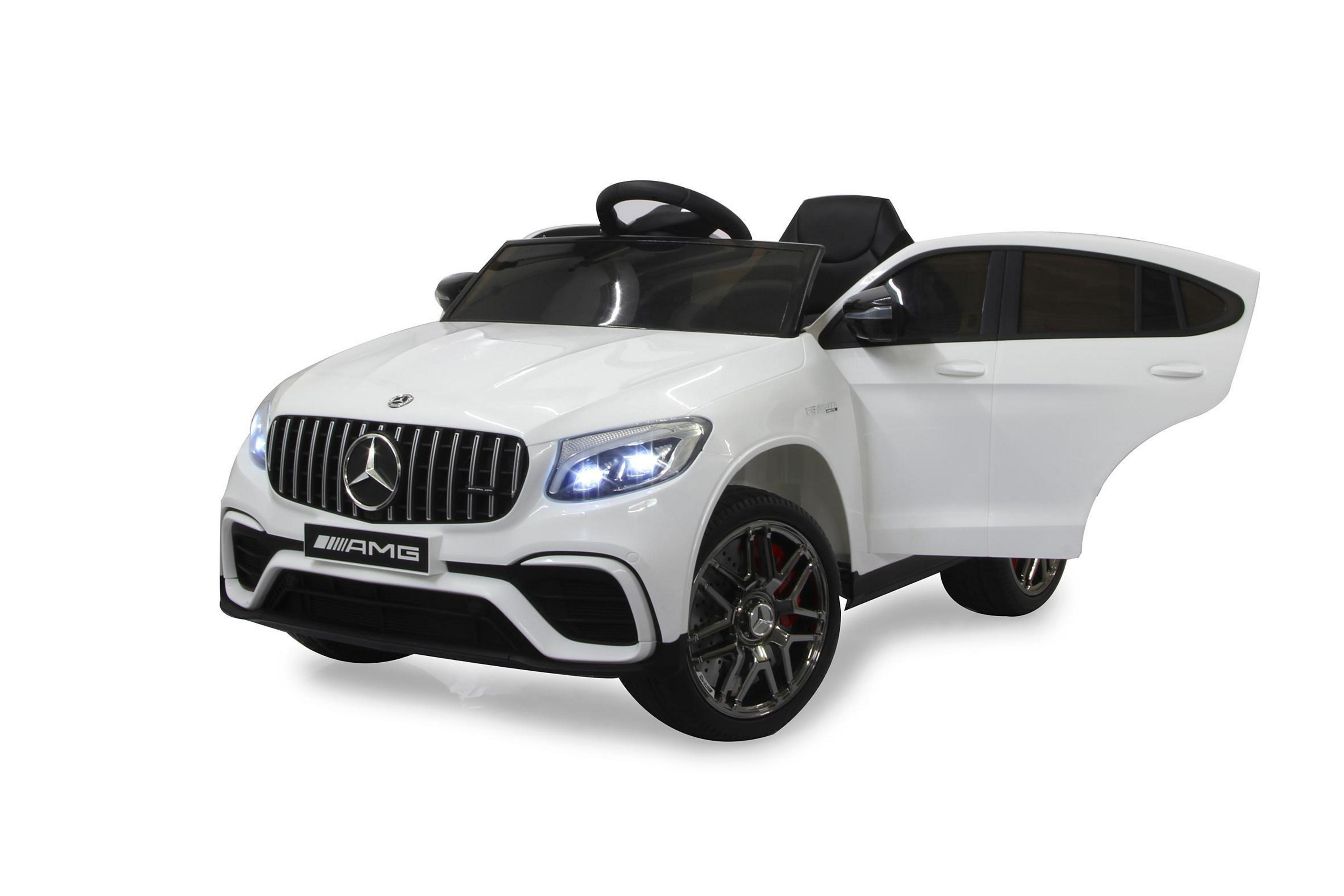 Weißes Spielzeugauto mit schwarzen Details. Offene Tür. Schwarzer Kühlergrill mit AMG-Logo. Weißer Hintergrund.