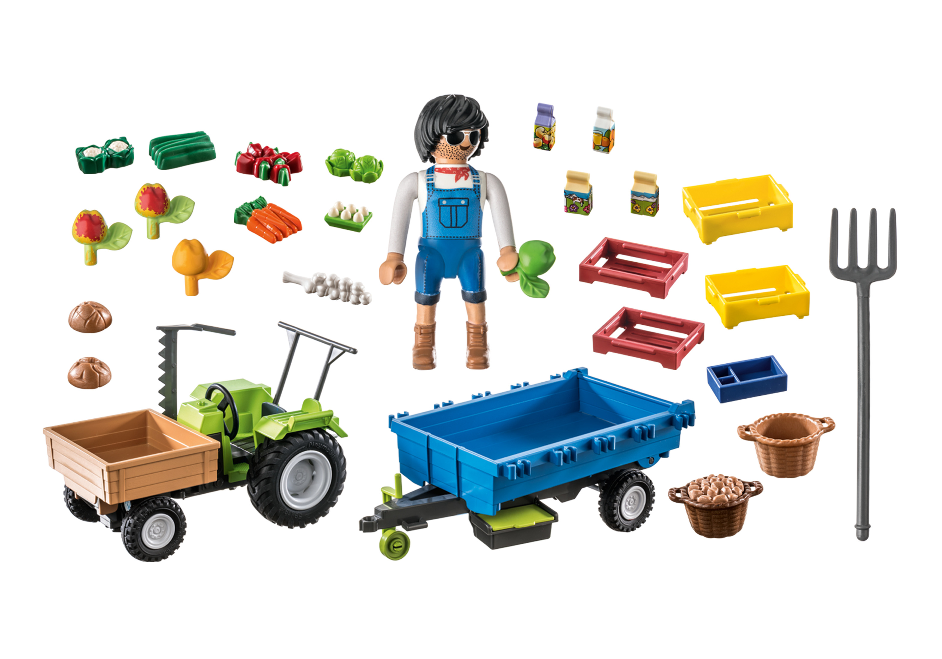 Eine Spielzeug-Bauernhofszene mit einem Bauern, Traktor, Anhänger und Gemüse.