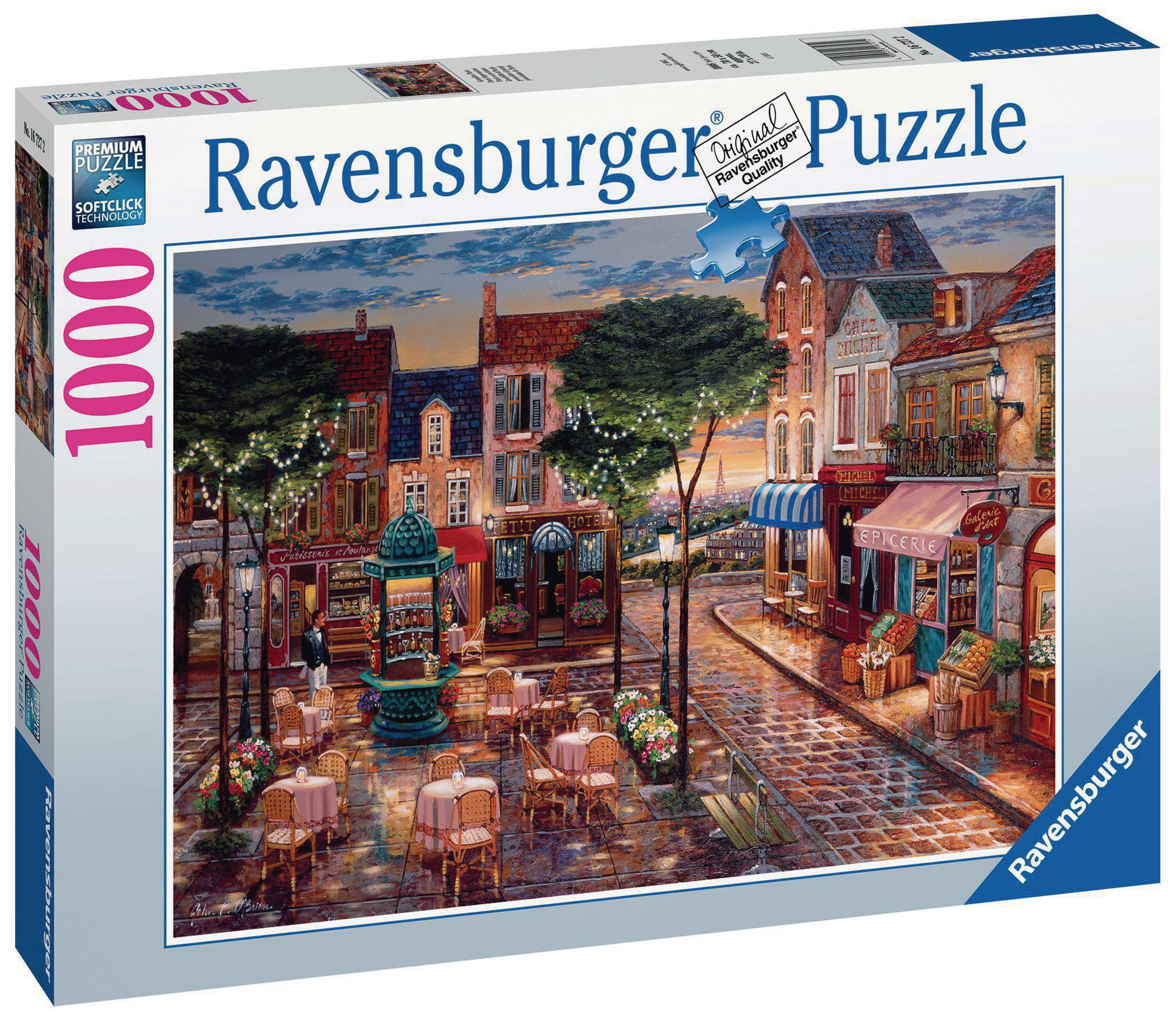 Ravensburger Puzzleschachtel mit einer Straßenszene mit Geschäften, Tischen und Bäumen bei Sonnenuntergang.