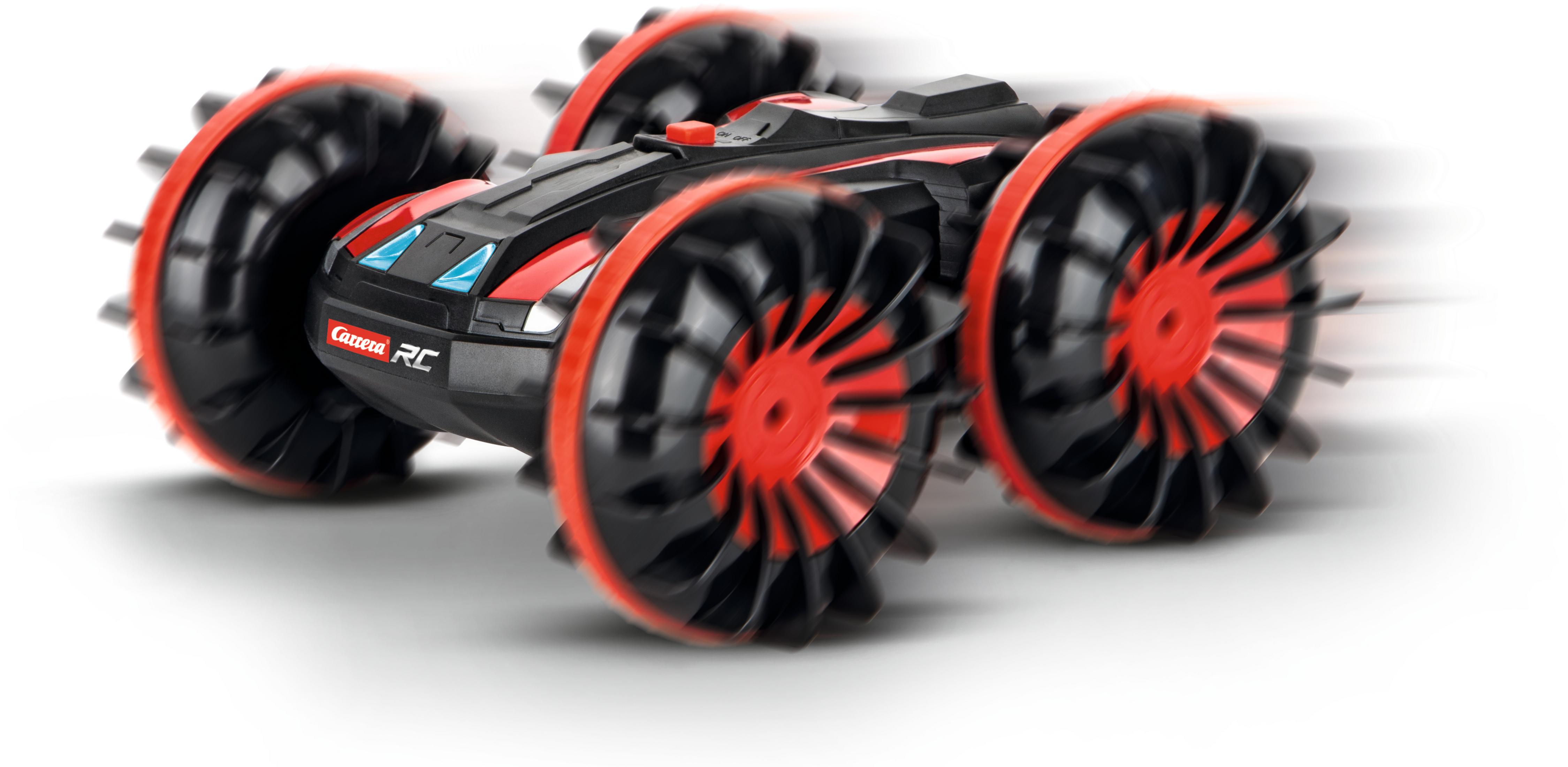 Ein schwarz-rotes ferngesteuertes Auto, Räder drehen sich schnell, auf weißem Hintergrund.