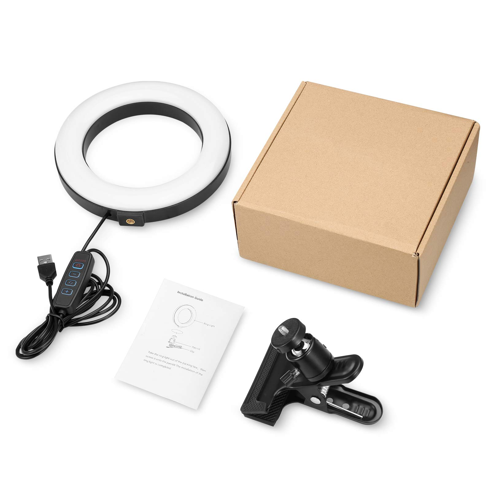 Ein Ringlicht, eine Box und anderes Zubehör liegen auf einer weißen Oberfläche. Eine schwarze Klammer ist ebenfalls vorhanden.
