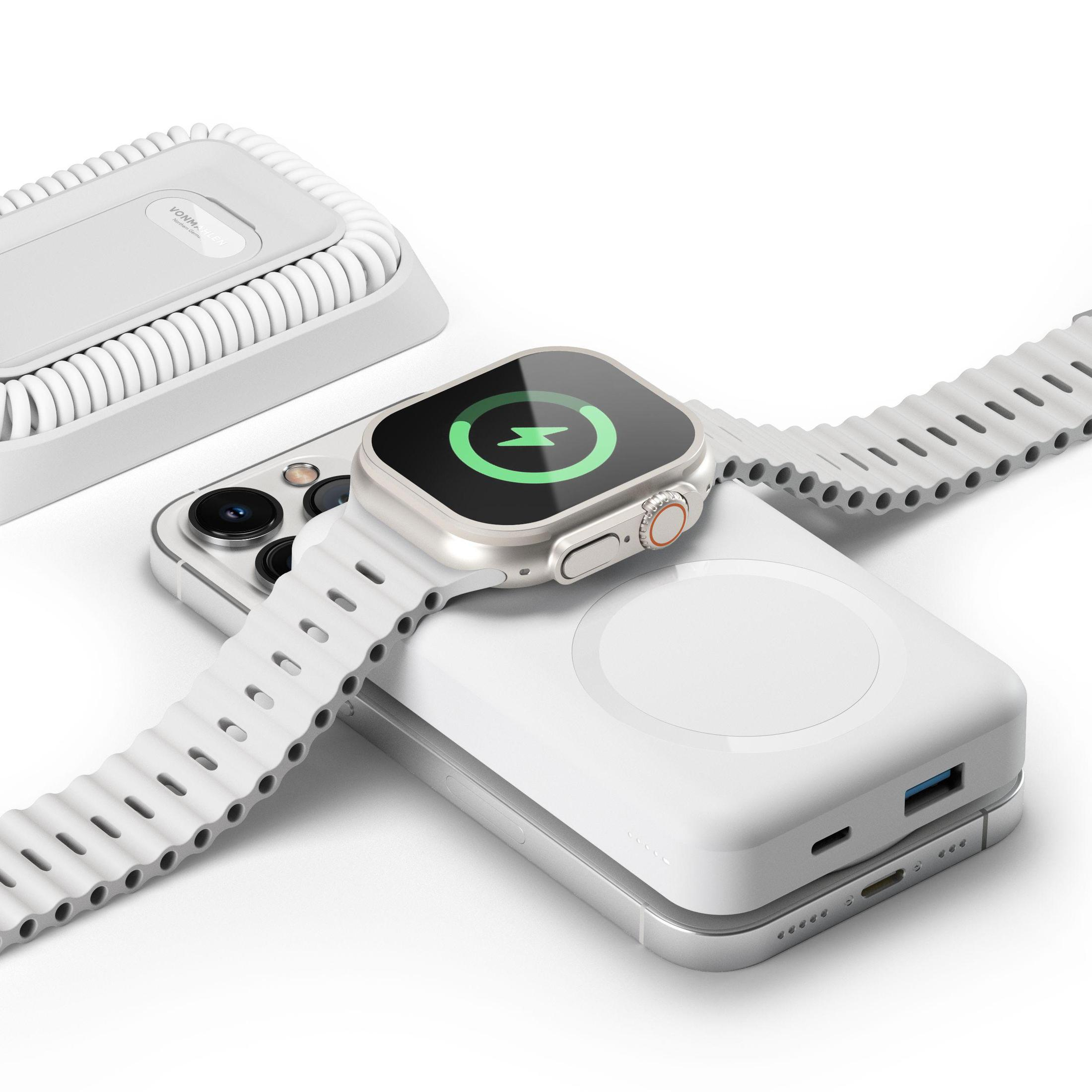 Apple Watch auf einem weißen Telefon, das auf einer Ladestation geladen wird.