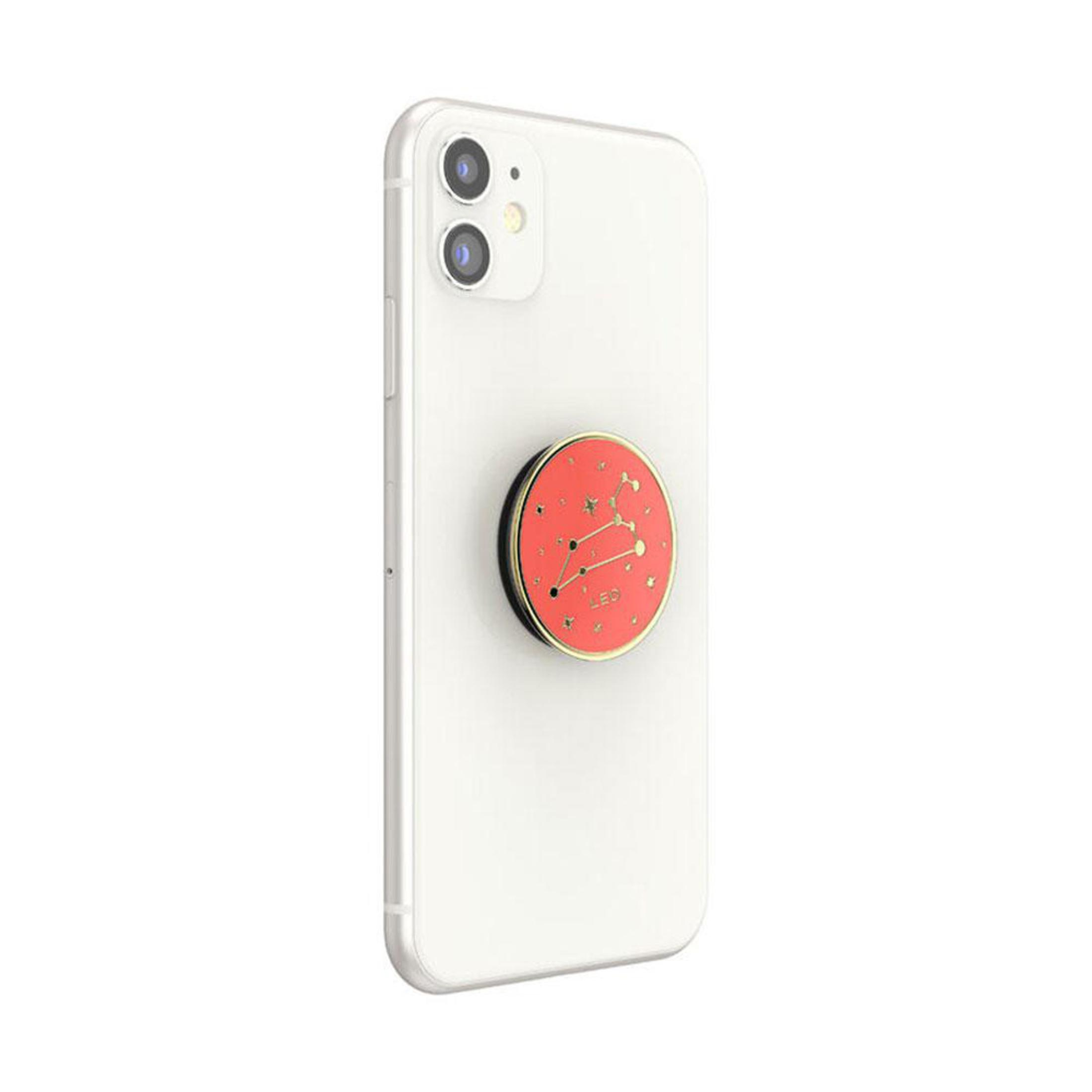Ein weißes Telefon mit einem roten und goldenen Pop-Socket mit Leo-Konstellationsdesign.