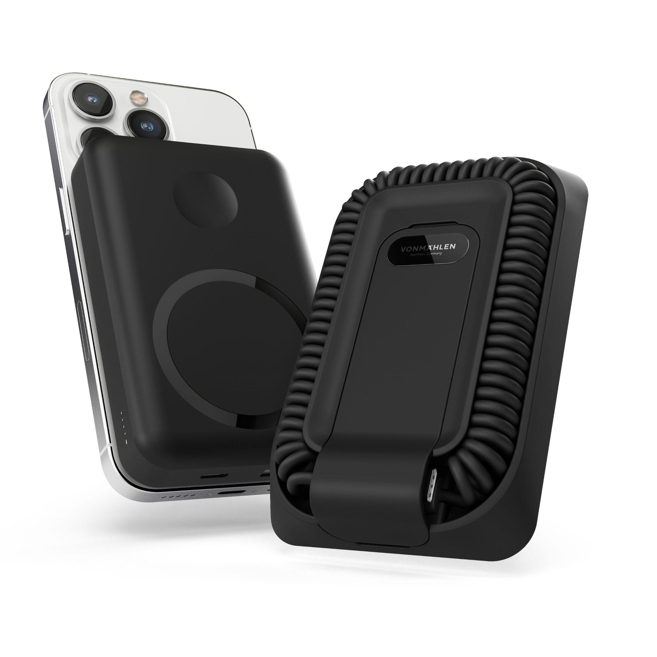 Ein schwarzes Telefon mit einem schwarzen Magnetladegerät. Das Ladegerät hat eine Spule, und das Telefon ist weiß.