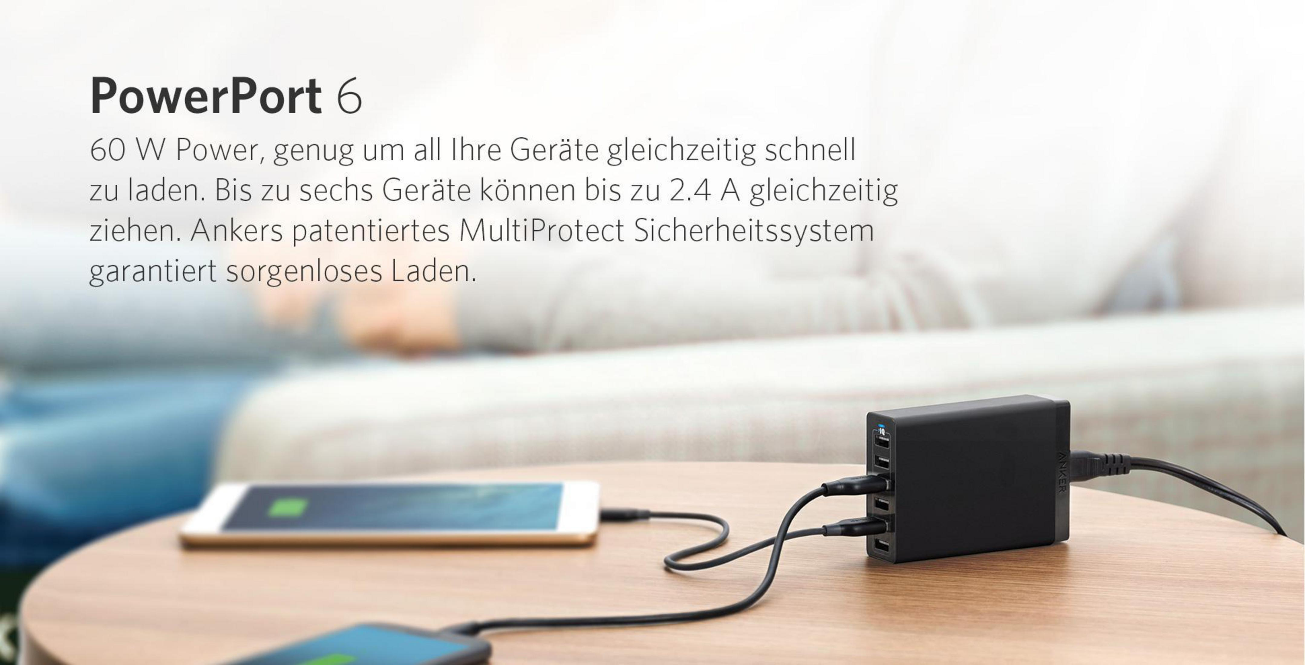 Schwarzes Netzteil mit mehreren USB-Anschlüssen. Zwei Telefone werden auf einem Holztisch geladen.