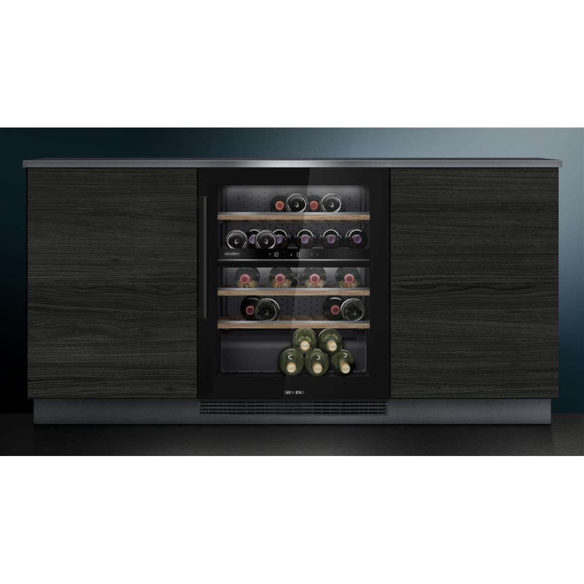 A wine cooler cabinet with wooden doors and shelves filled with wine bottles. The background is dark.