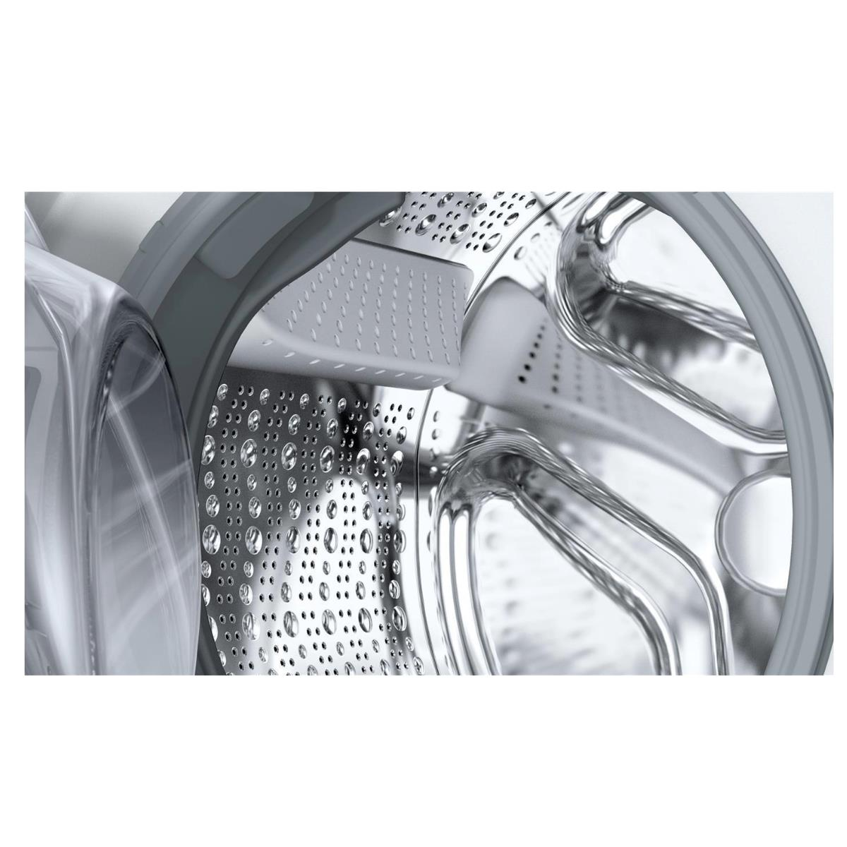 Wnętrze bębna pralki. Jest biały dozownik detergentu.