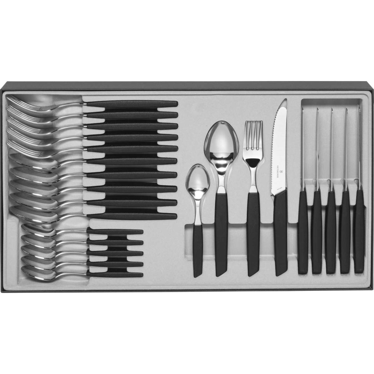 Un set di posate in un vassoio. Il set include cucchiai, forchette, coltelli e coltelli da bistecca, tutti con manici neri.