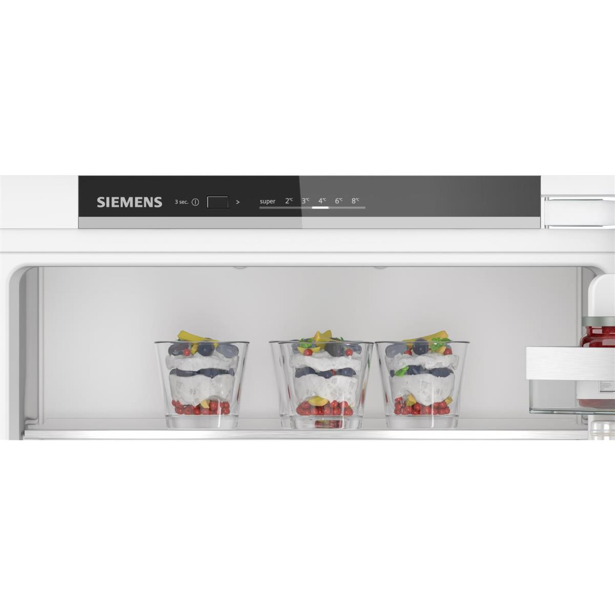 A fridge interior with three desserts in glasses. Temperature settings are above the desserts.
