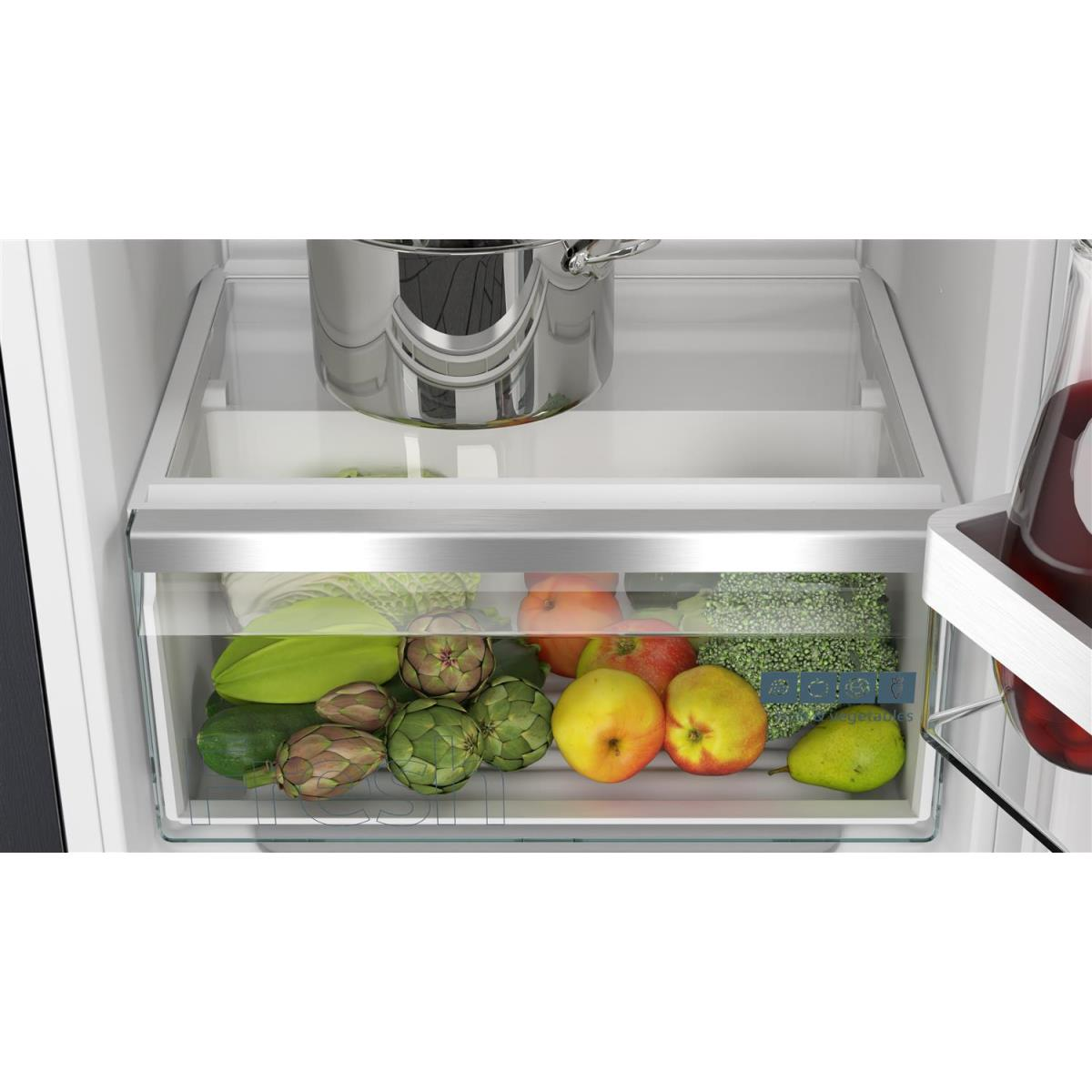 Refrigerator drawer filled with fresh produce: zucchini, artichokes, apples, pears, and more.